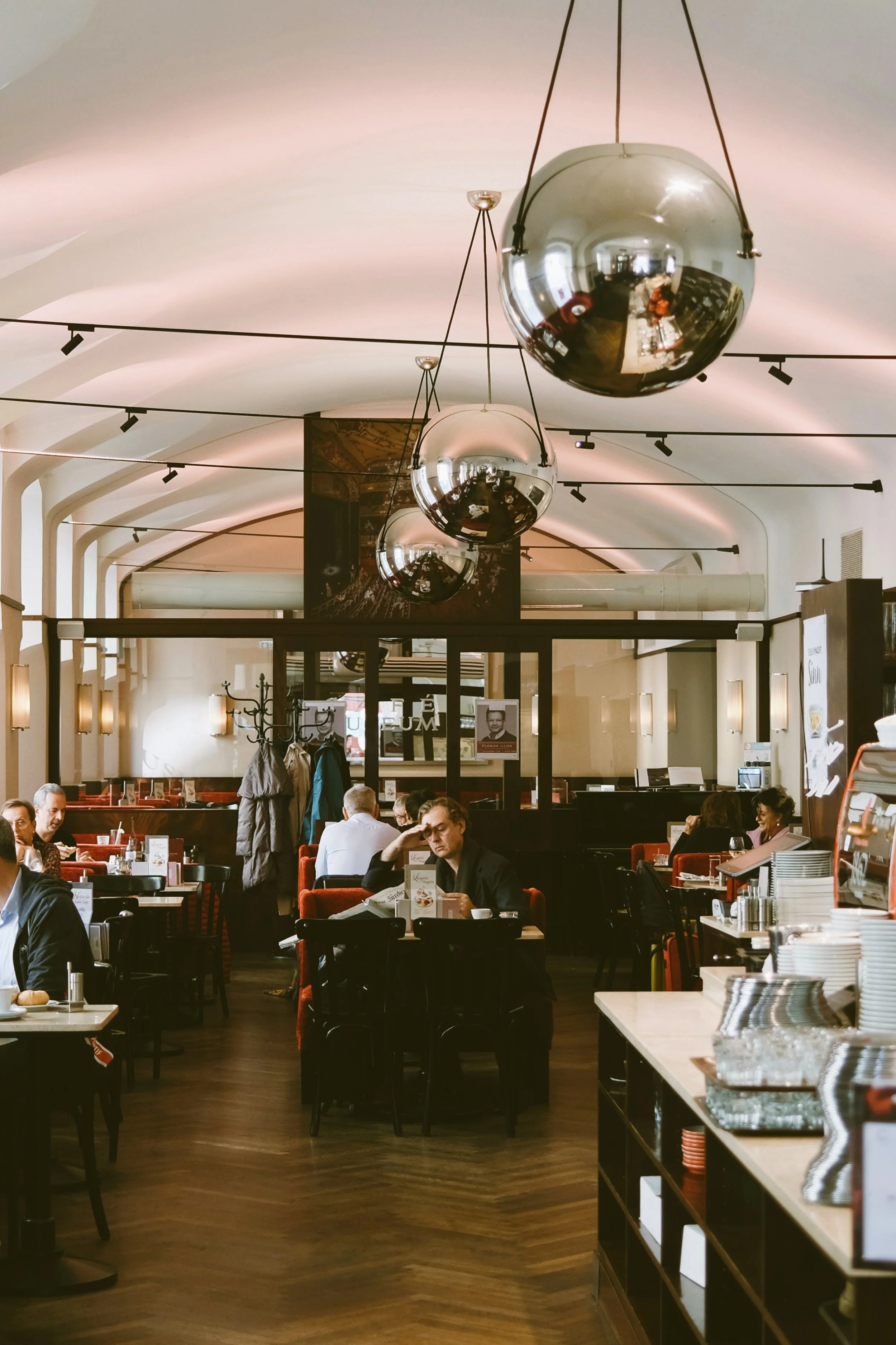 Reinthaler's Beisl interior with wooden floors, a large disco ball hanging from the ceiling and diners at the tables, Vienna.