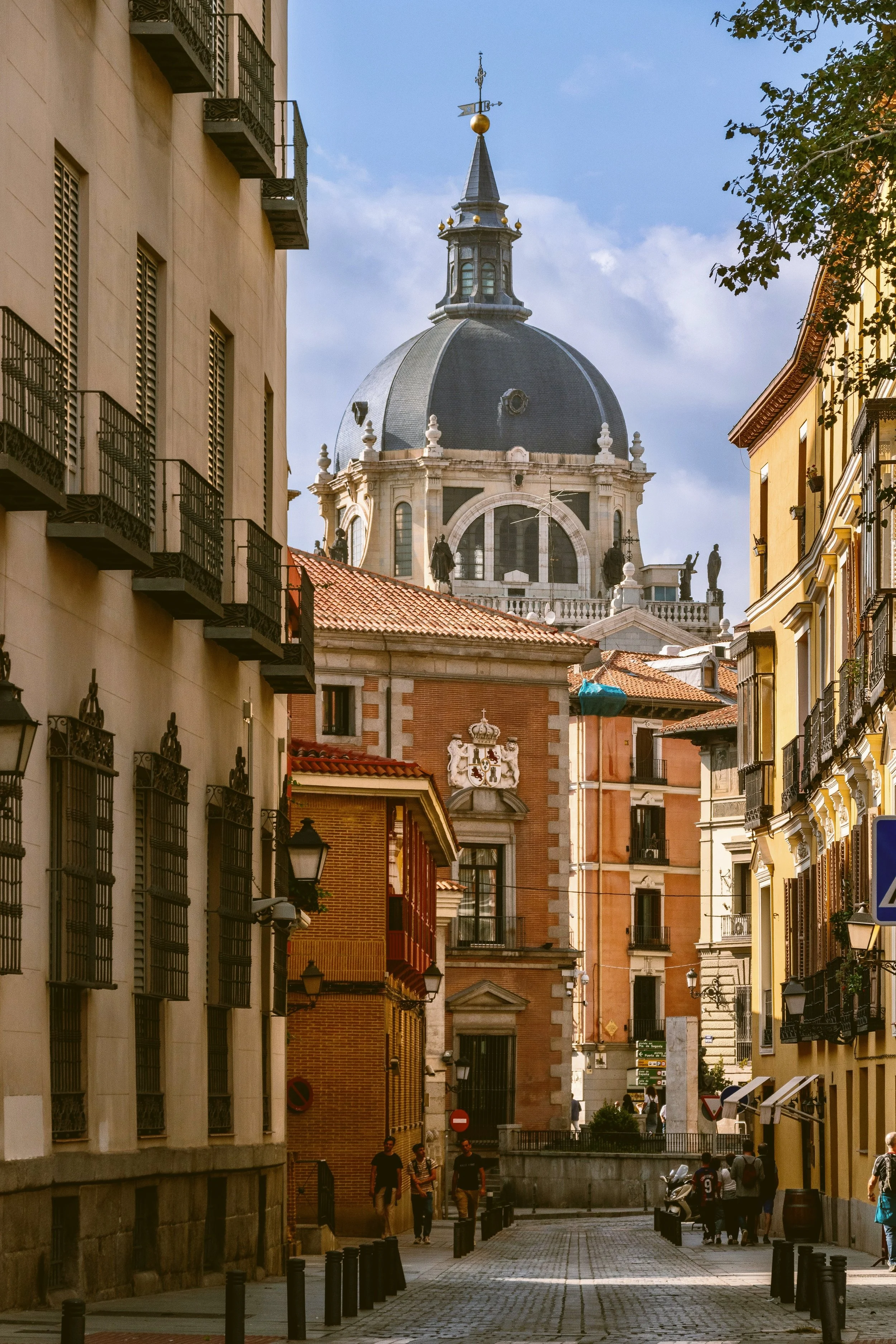 Cobbled street lined with brick and ochre historic buildings in the Habsburg quarter, Madrid