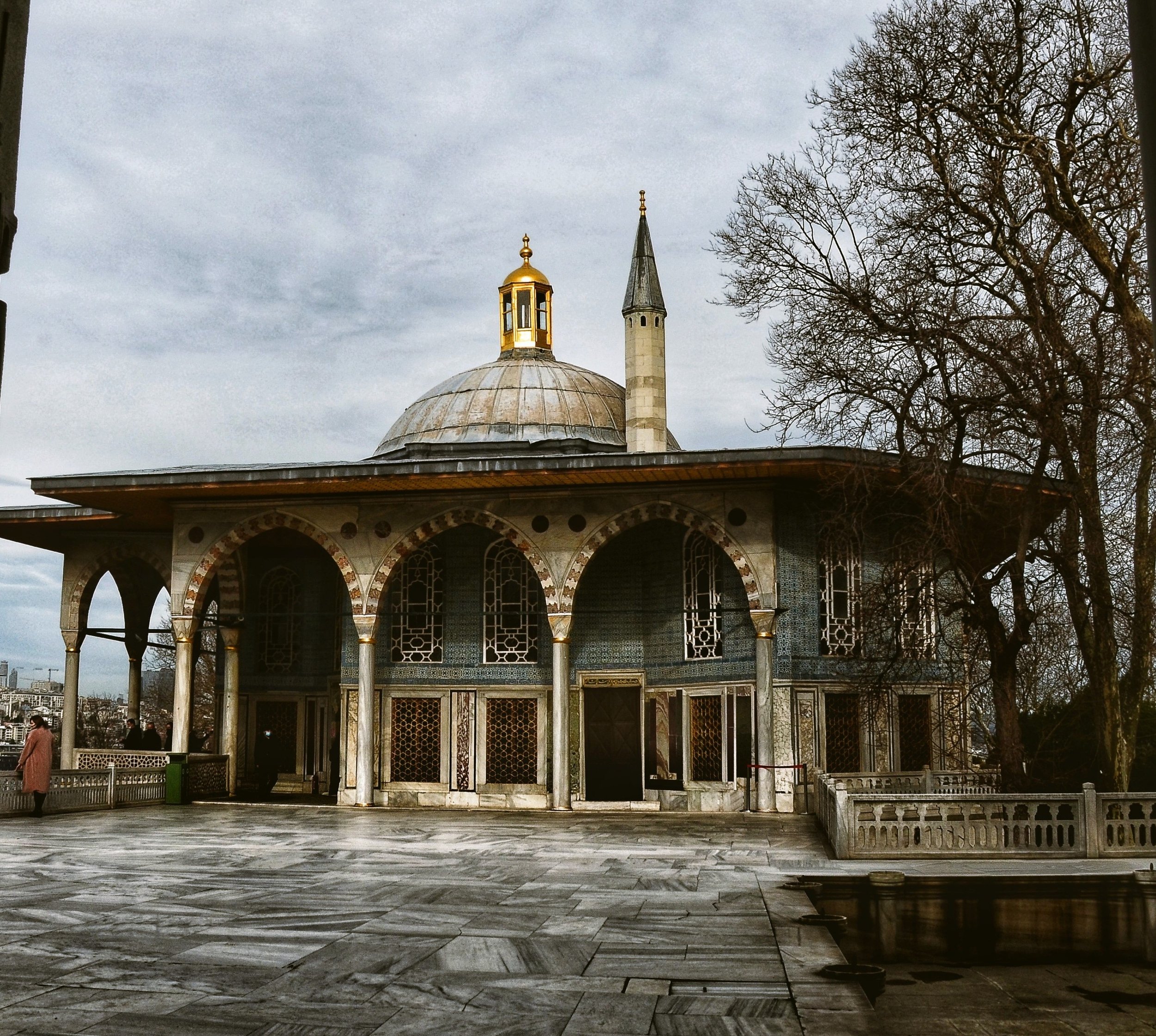 Domed pavilion with an open arcade on a stone terrace and a minaret behind it, Topkapı Palace, Istanbul.