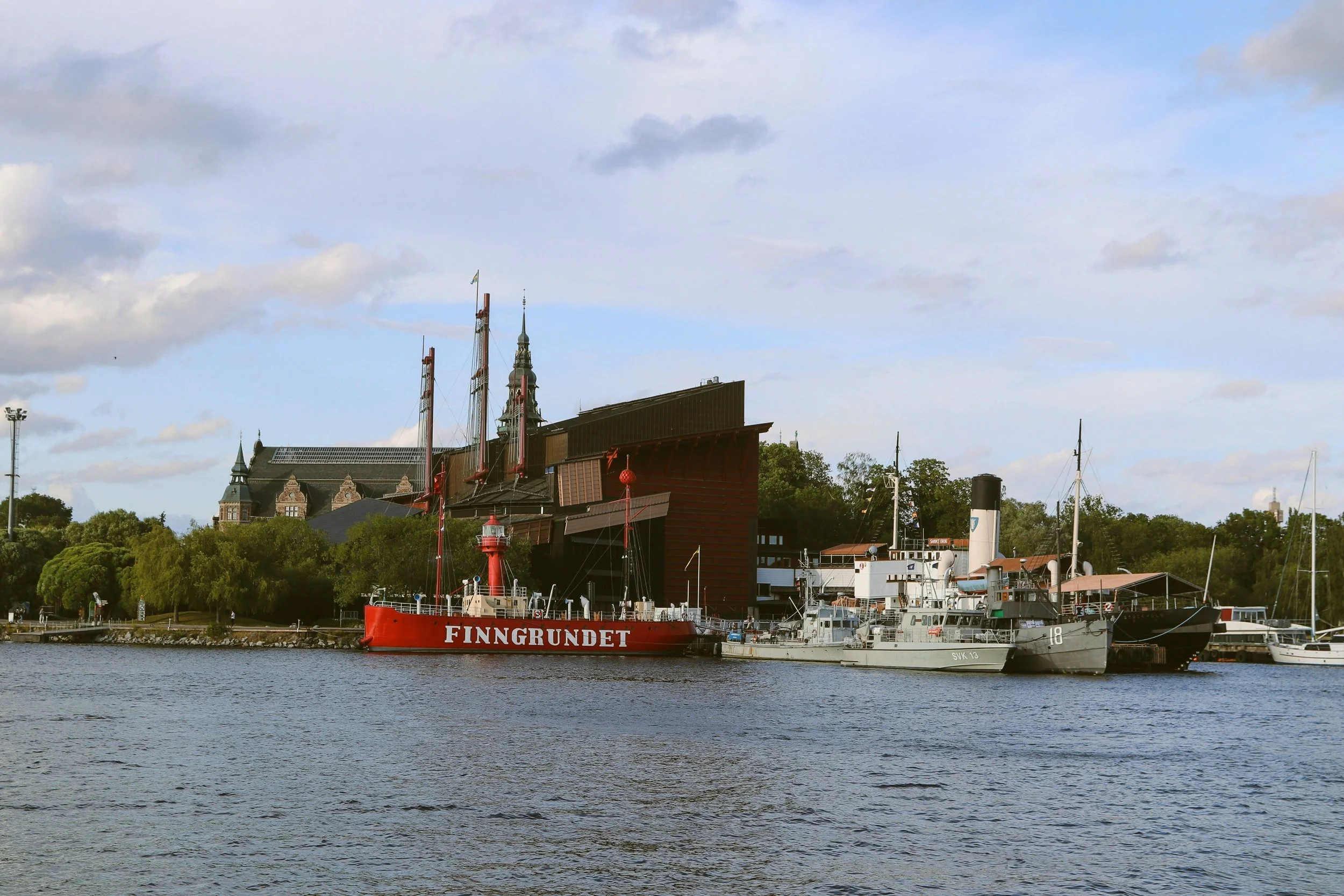 Vasa Museum on Djurgården island seen across the water, with boats moored in front, Stockholm