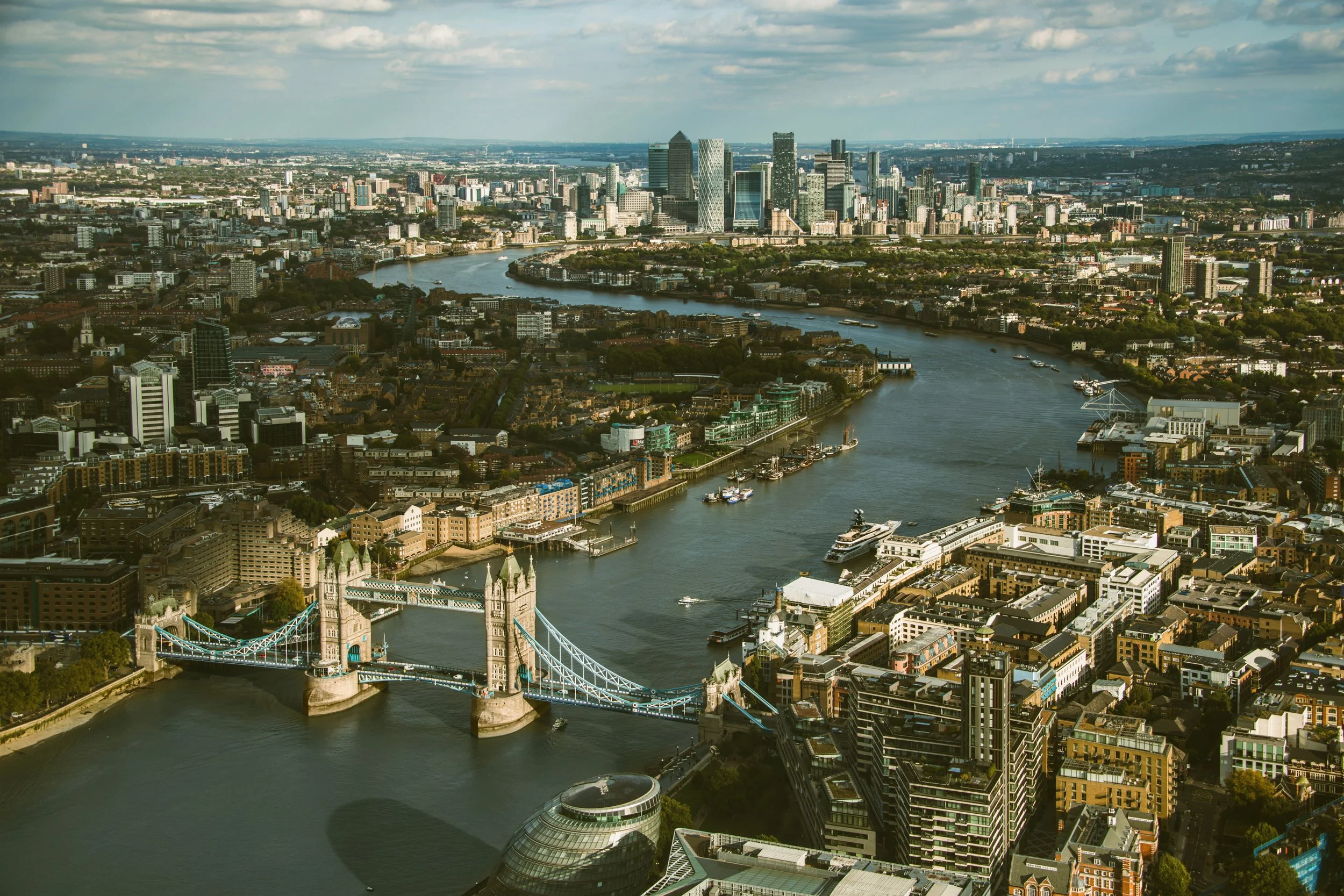 Aerial view of Tower Bridge crossing the River Thames with the London skyline behind