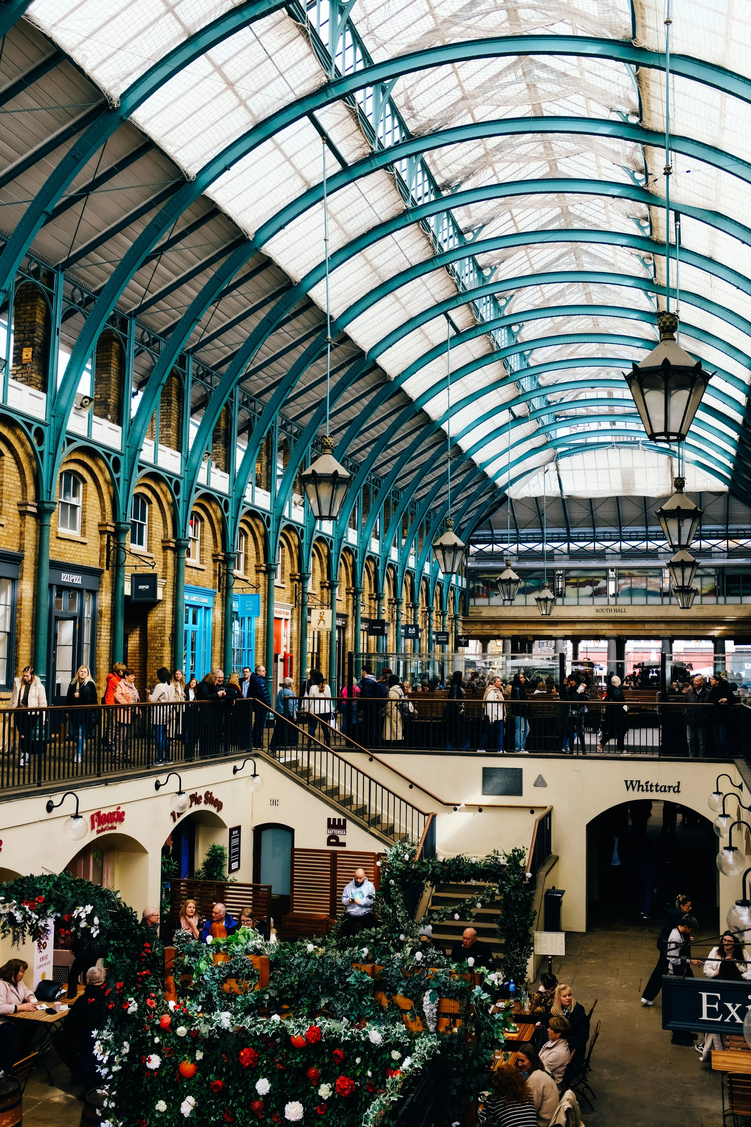 Covent Garden Market hall with its glass roof and rows of stalls, London.