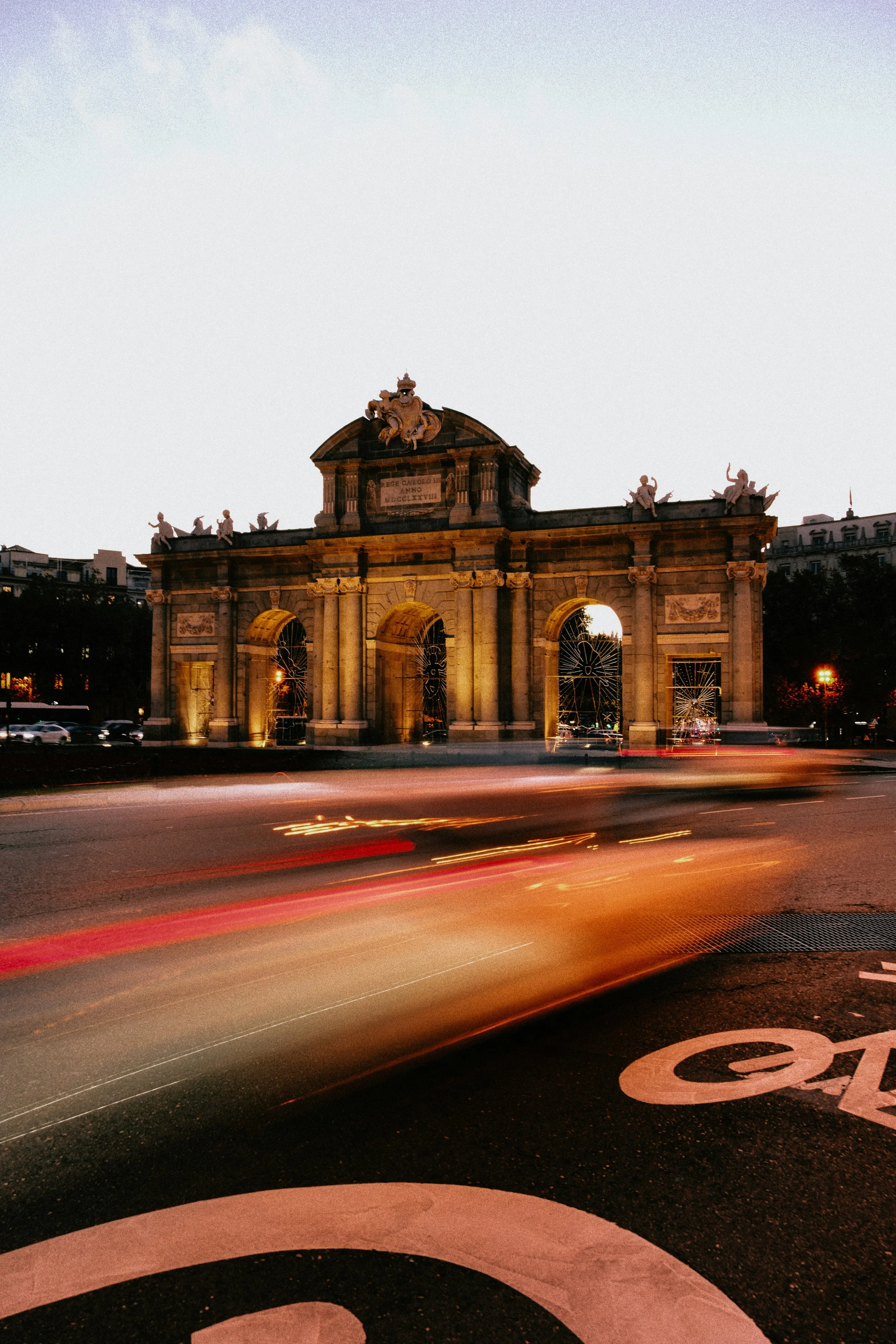 Puerta de Alcalá at dusk with light trails from passing traffic, Madrid