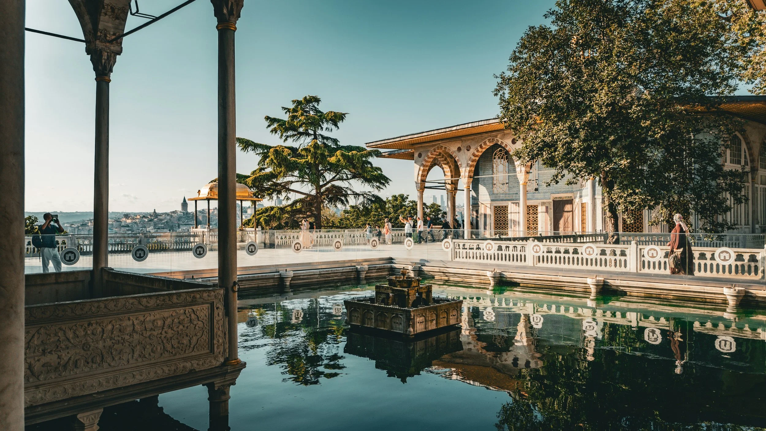 Terrace with a reflecting pool and a pavilion among trees, with the water in the distance, Topkapı Palace, Istanbul.