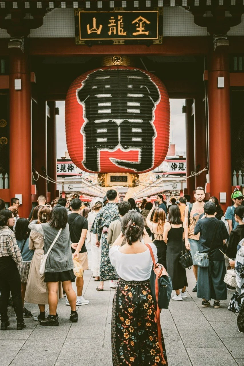 Giant red paper lantern hanging in the Kaminarimon gate with visitors gathered below, Sensō-ji, Asakusa, Tokyo