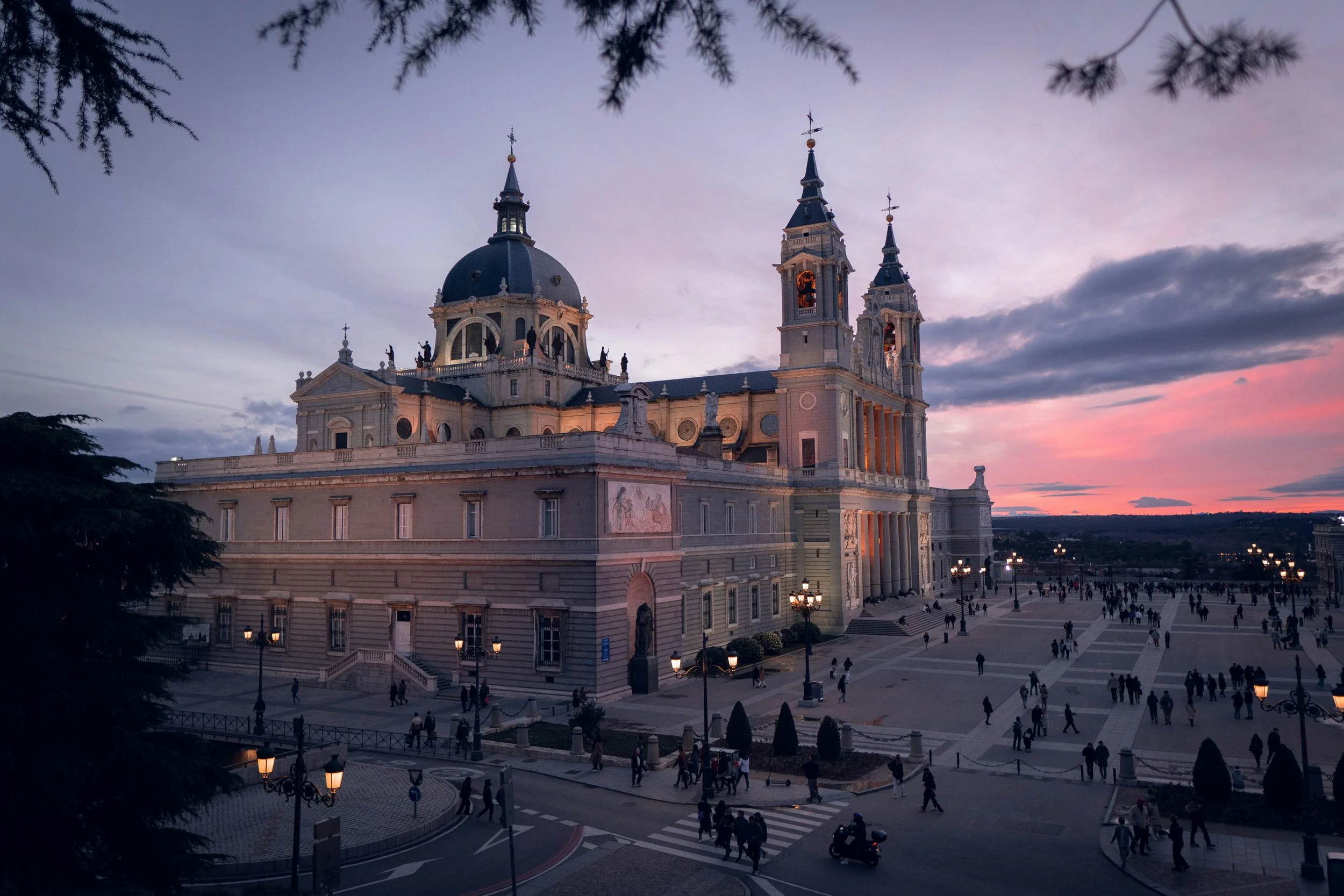 Almudena Cathedral with its dome and bell towers under a pink sunset sky, Madrid