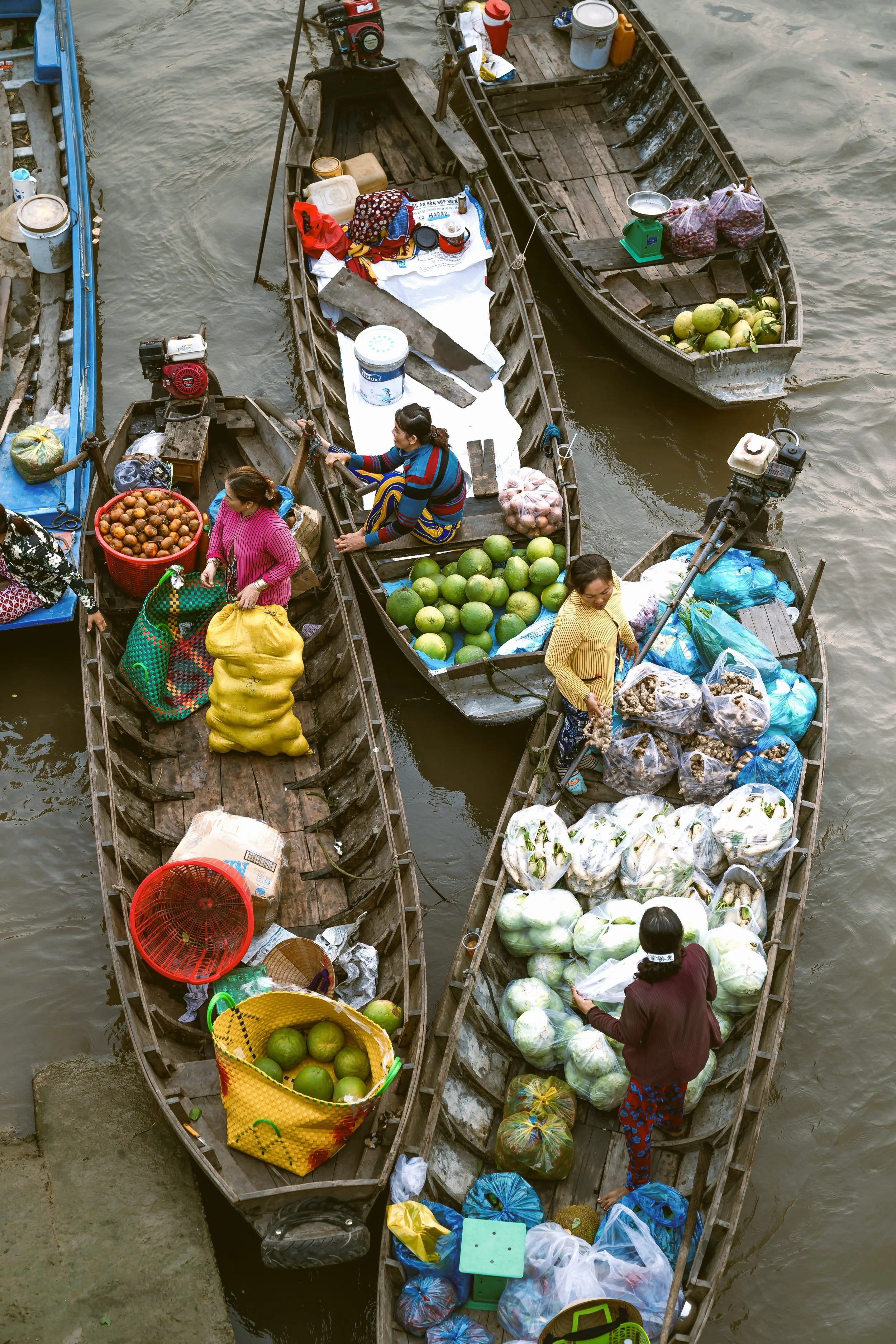 Wooden boats packed side by side with vendors at a floating market canal, Bangkok