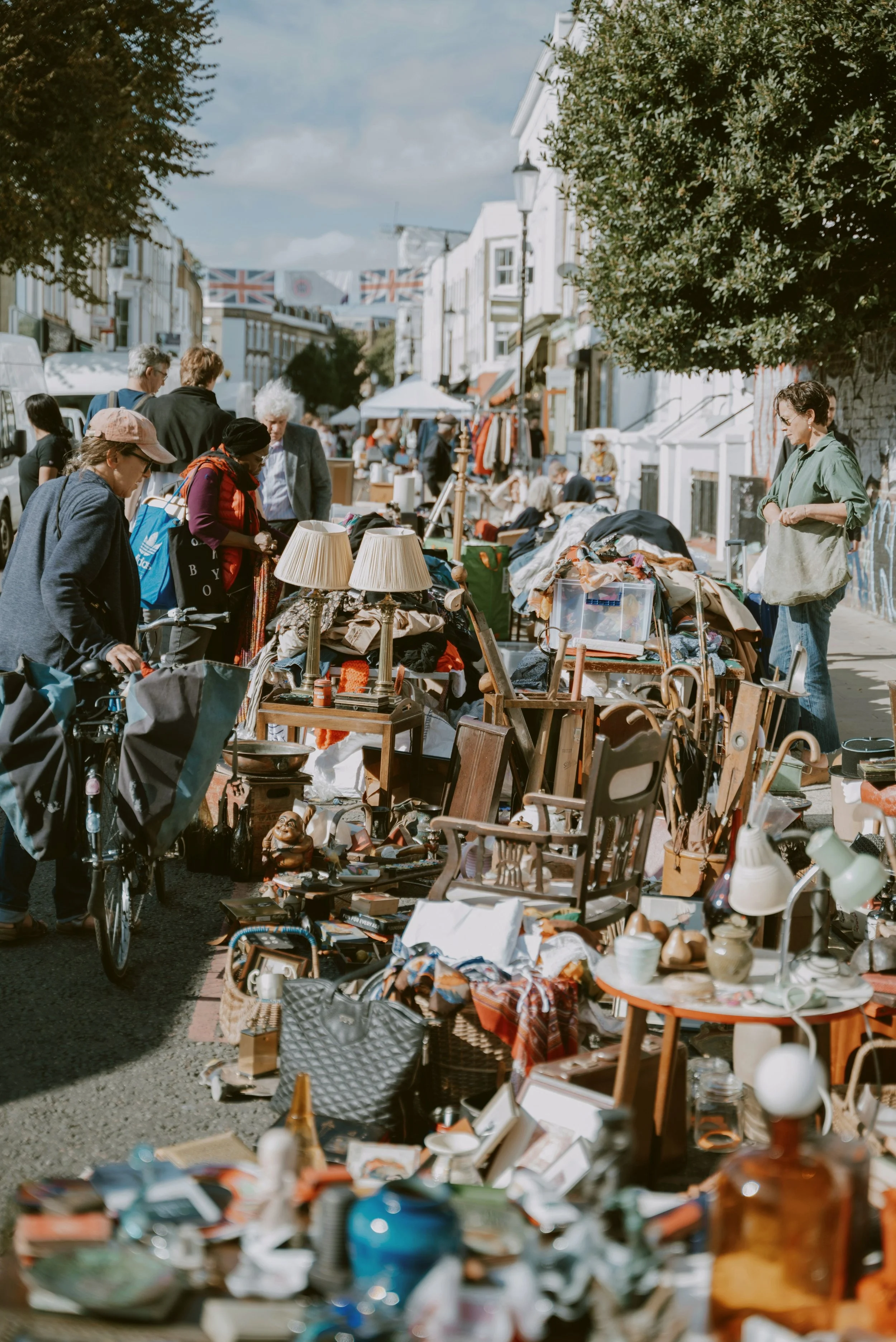Crowded flea market stalls packed with antiques and bric-a-brac on Portobello Road, London.