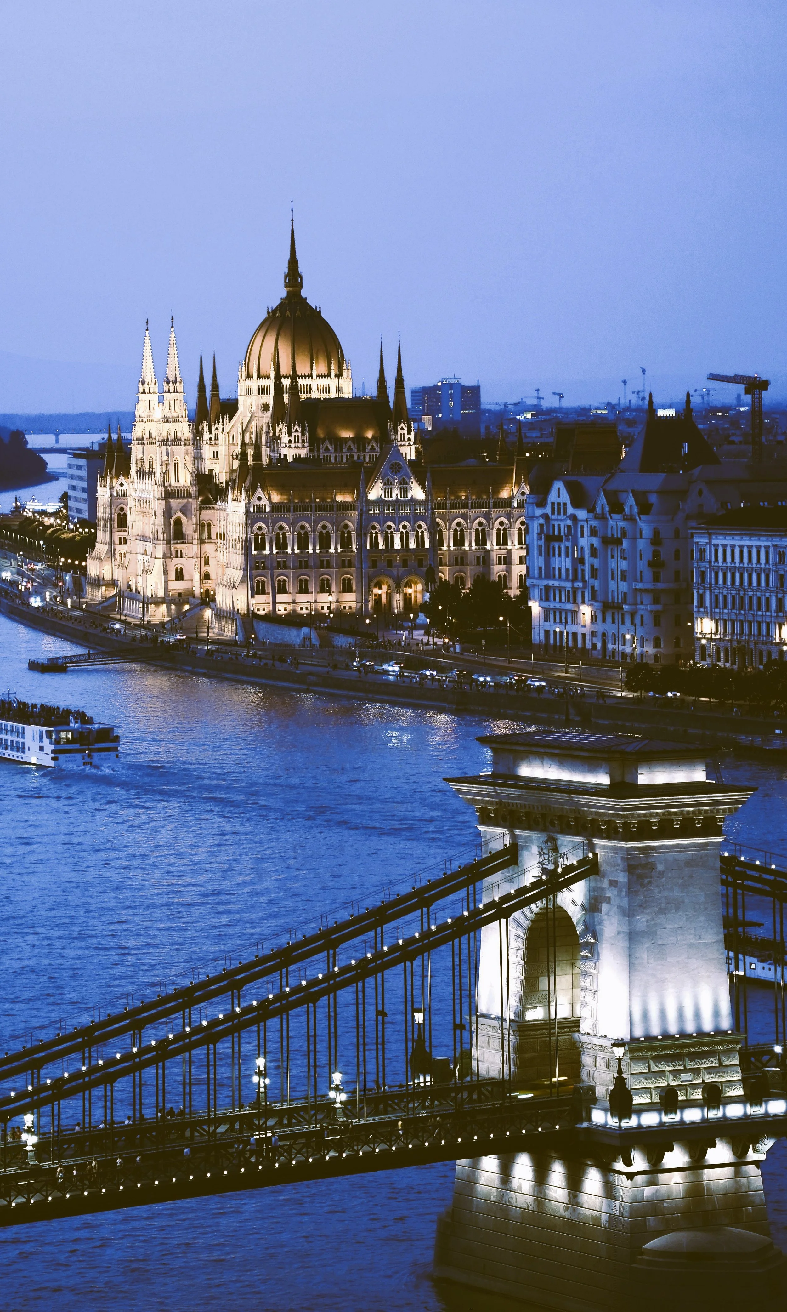 Chain Bridge and Hungarian Parliament lit at dusk over the Danube, Budapest