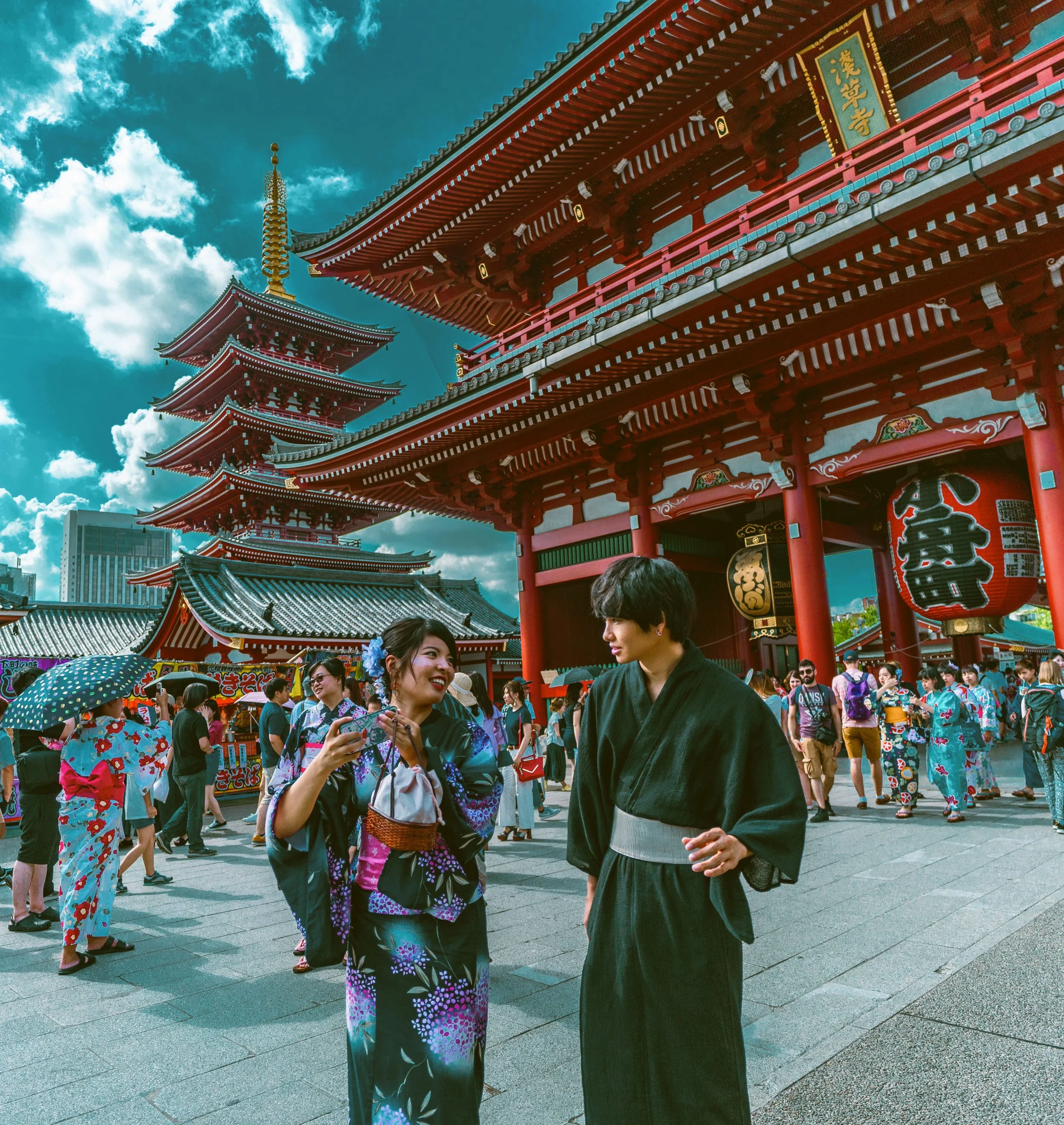 Person in a kimono walking in front of the red pagoda and temple buildings, Sensō-ji, Asakusa, Tokyo