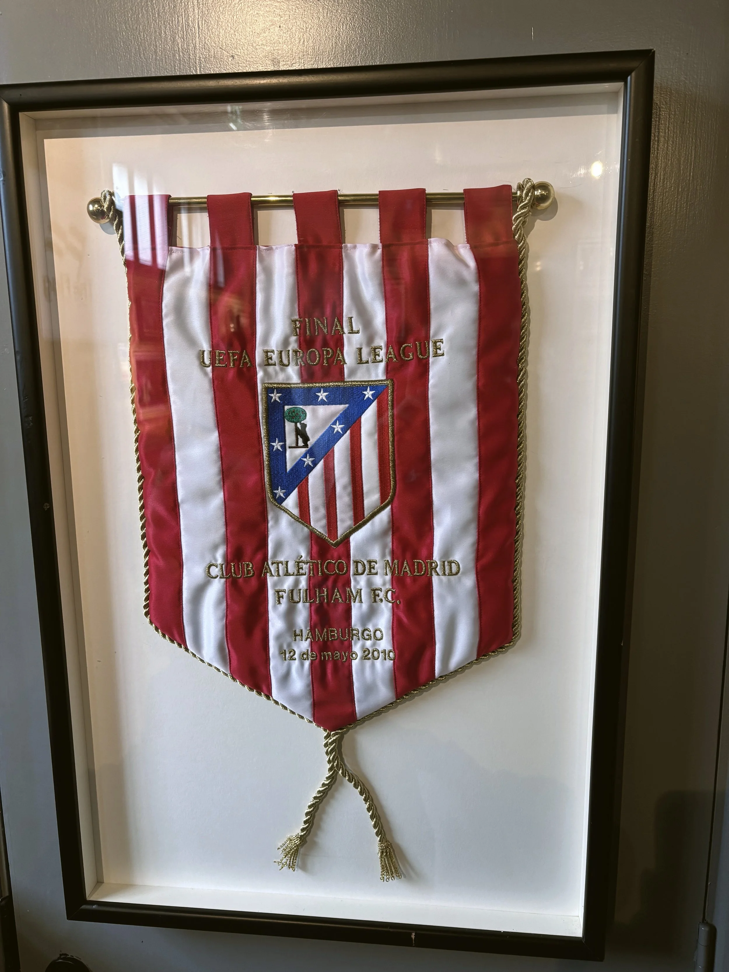 Embroidered flag with red and white stripes, featuring the Atletico Madrid club crest.