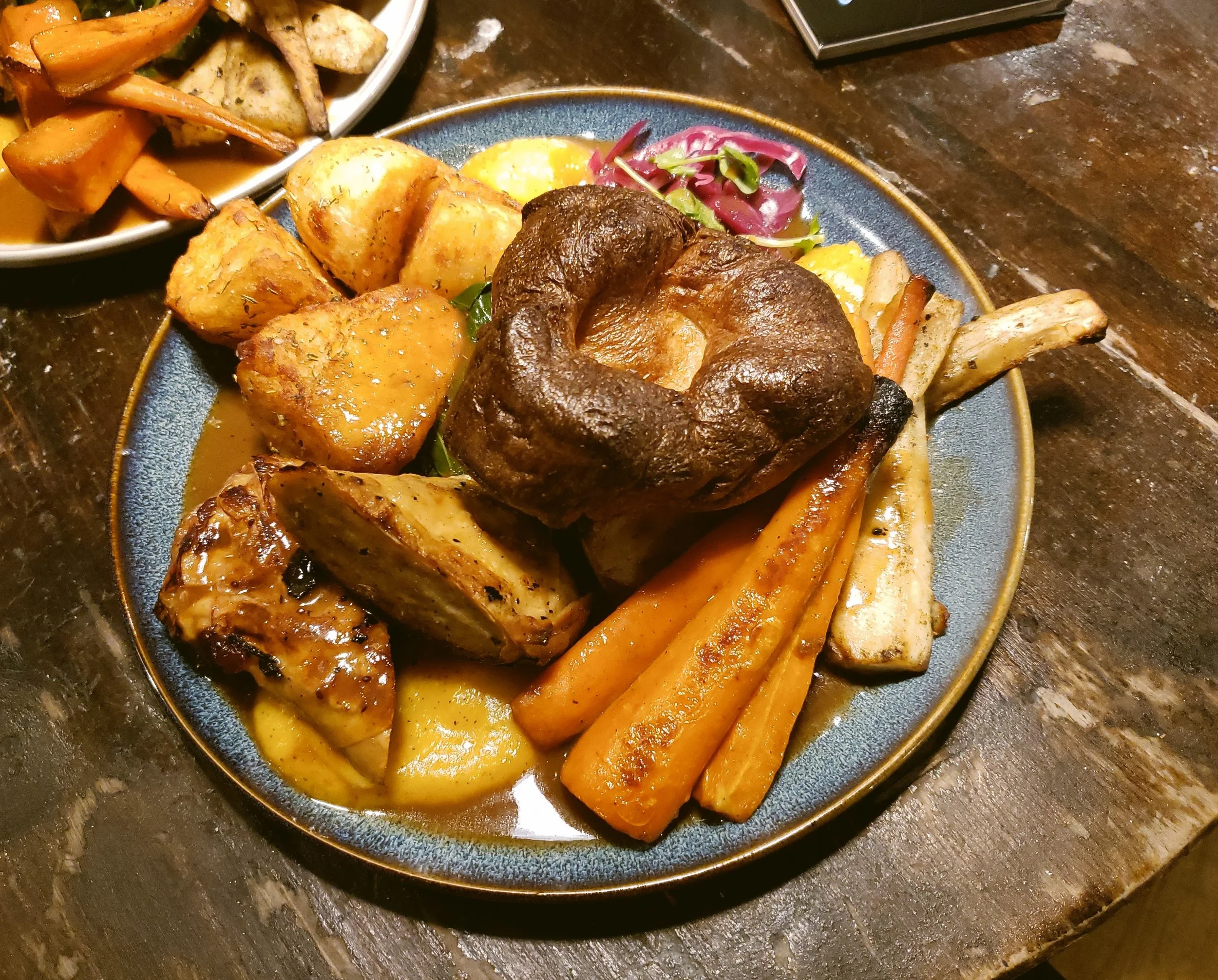 Sunday roast with meat, roast potatoes and carrots on a plate.