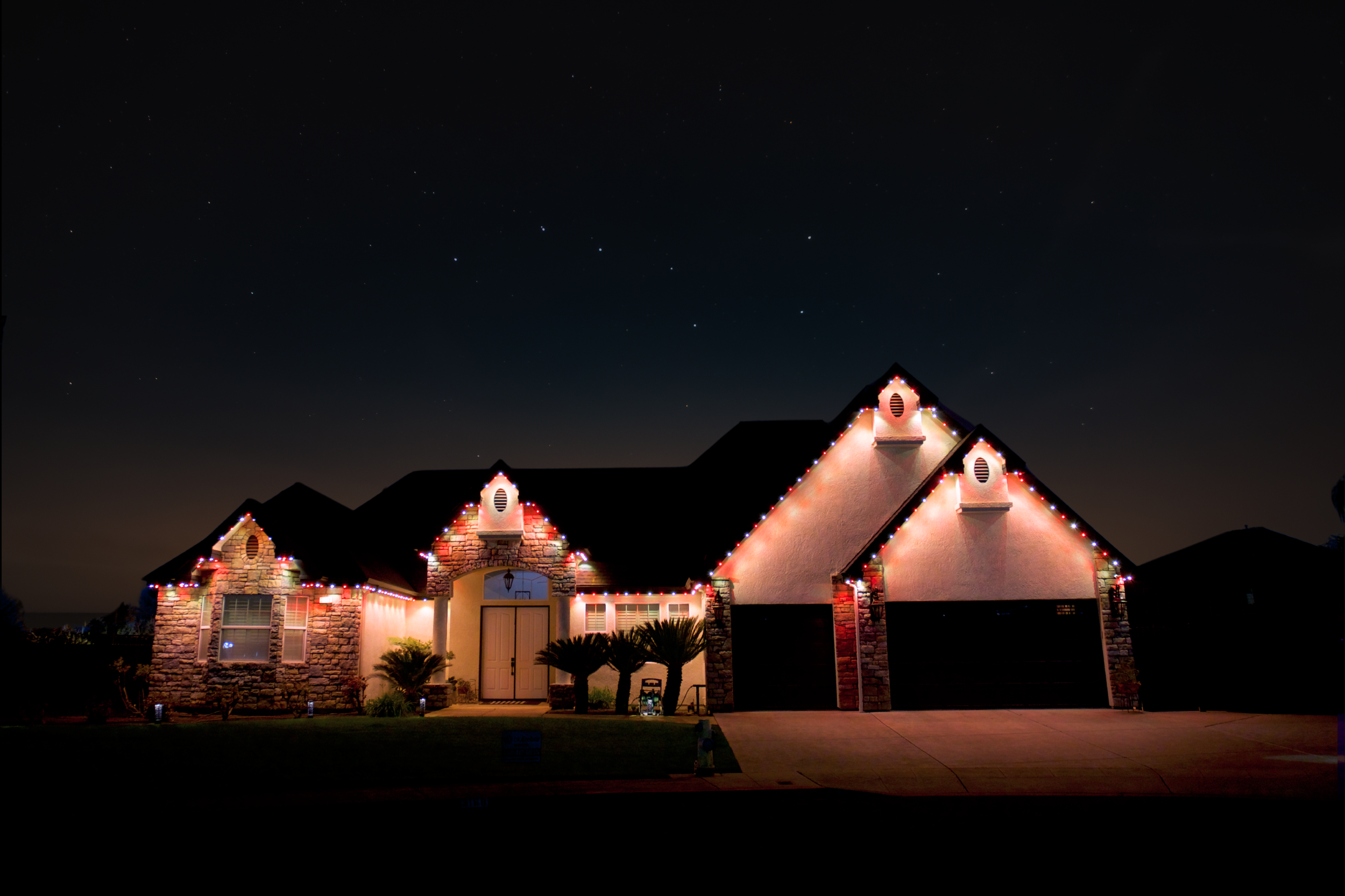A house decorated with Christmas lights at night.
