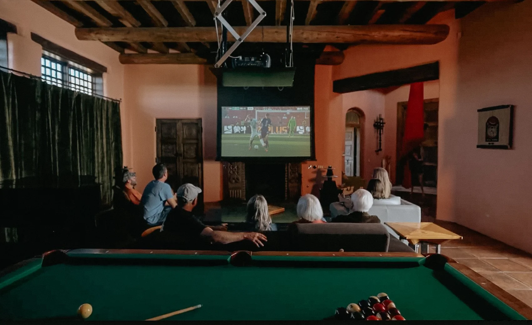 Entertainment room with billiards table and large-screen theater at SENDERO Taos NM luxury compound