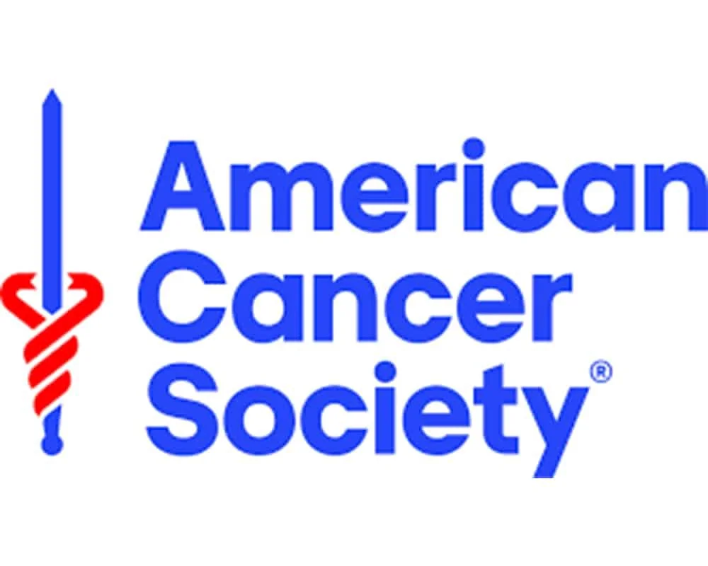 The logo of the American Cancer Society, featuring a blue sword with a red ribbon wrapped around it.