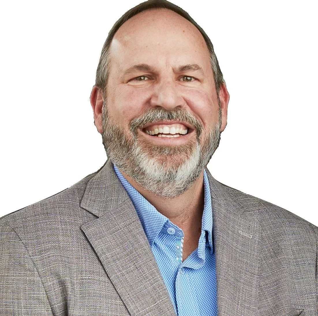 A middle-aged man with a beard and short hair, smiling, wearing a gray blazer and checked blue shirt against a white background.