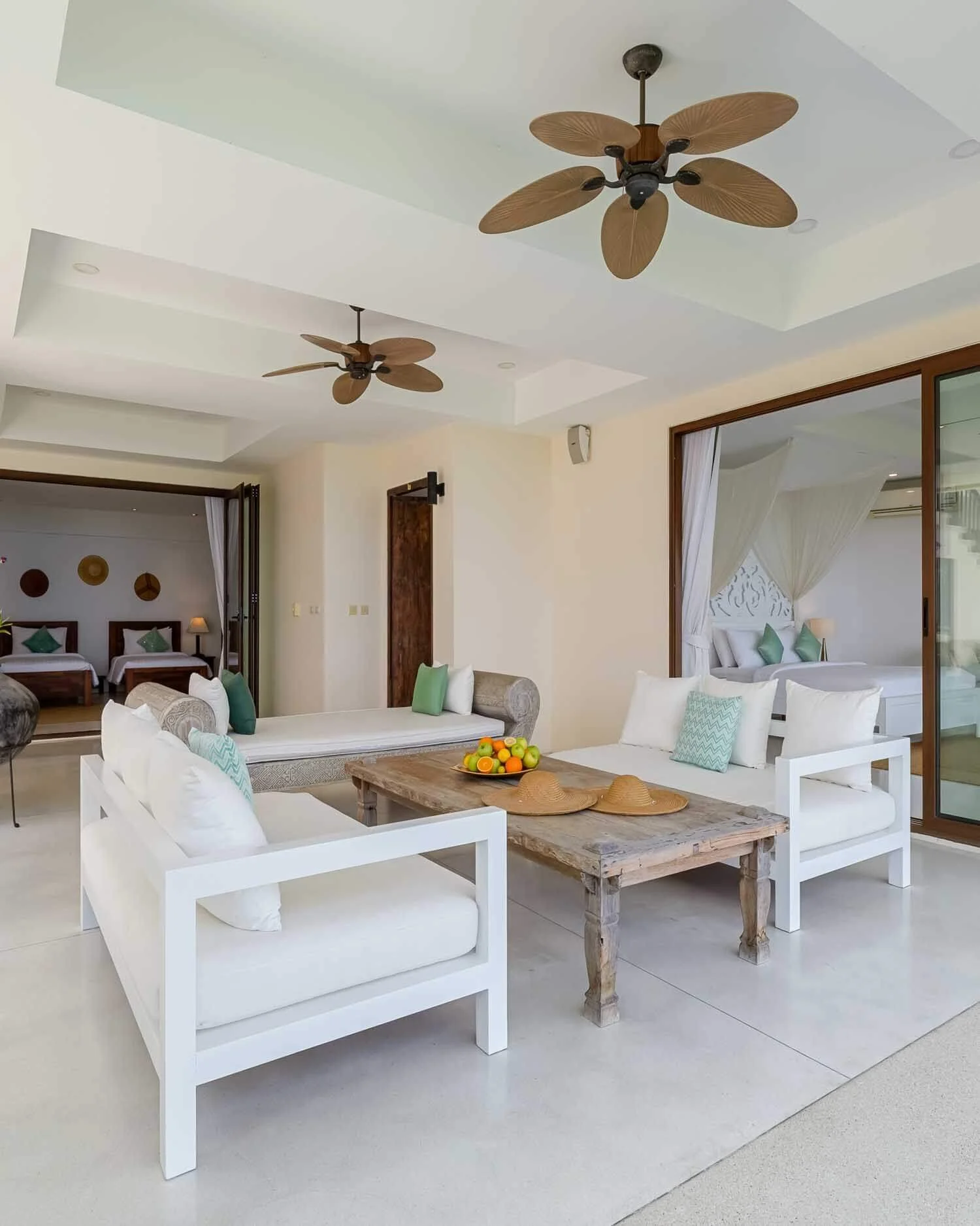 Outdoor lounge area with white seating and a rustic wooden coffee table outside the Twin Suite at Saensook eco villa