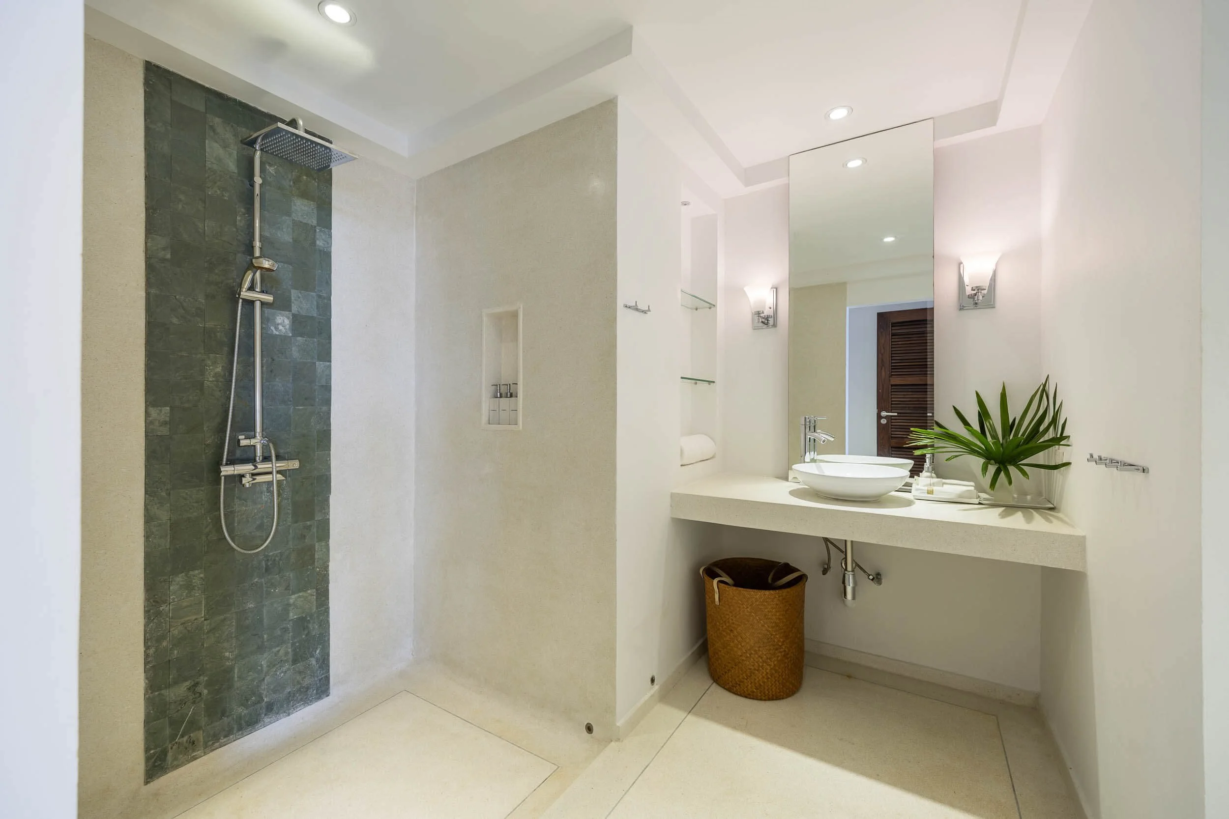 Modern en-suite bathroom in the Twin Suite featuring a glass-walled slate tile shower and a minimalist vanity with a vessel sink
