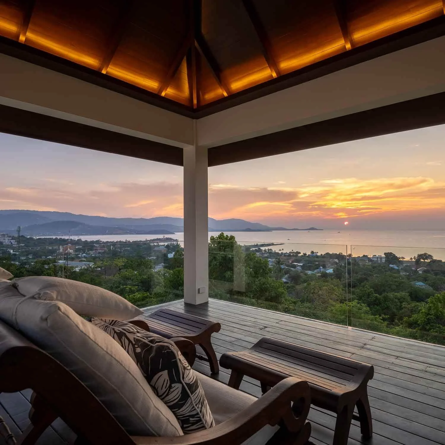 Panoramic view of the tropical coastline and lush palm-fringed hills surrounding Saensook Villa in Koh Samui, Thailand.