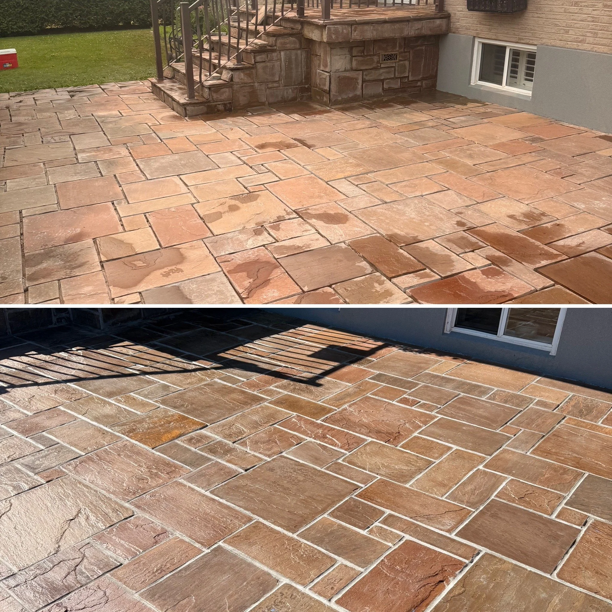 A backyard patio made of multicolored stone or tile, with steps leading up to a wooden deck. A small window is visible on the house, and there is a grassy lawn with a red cooler in the background.