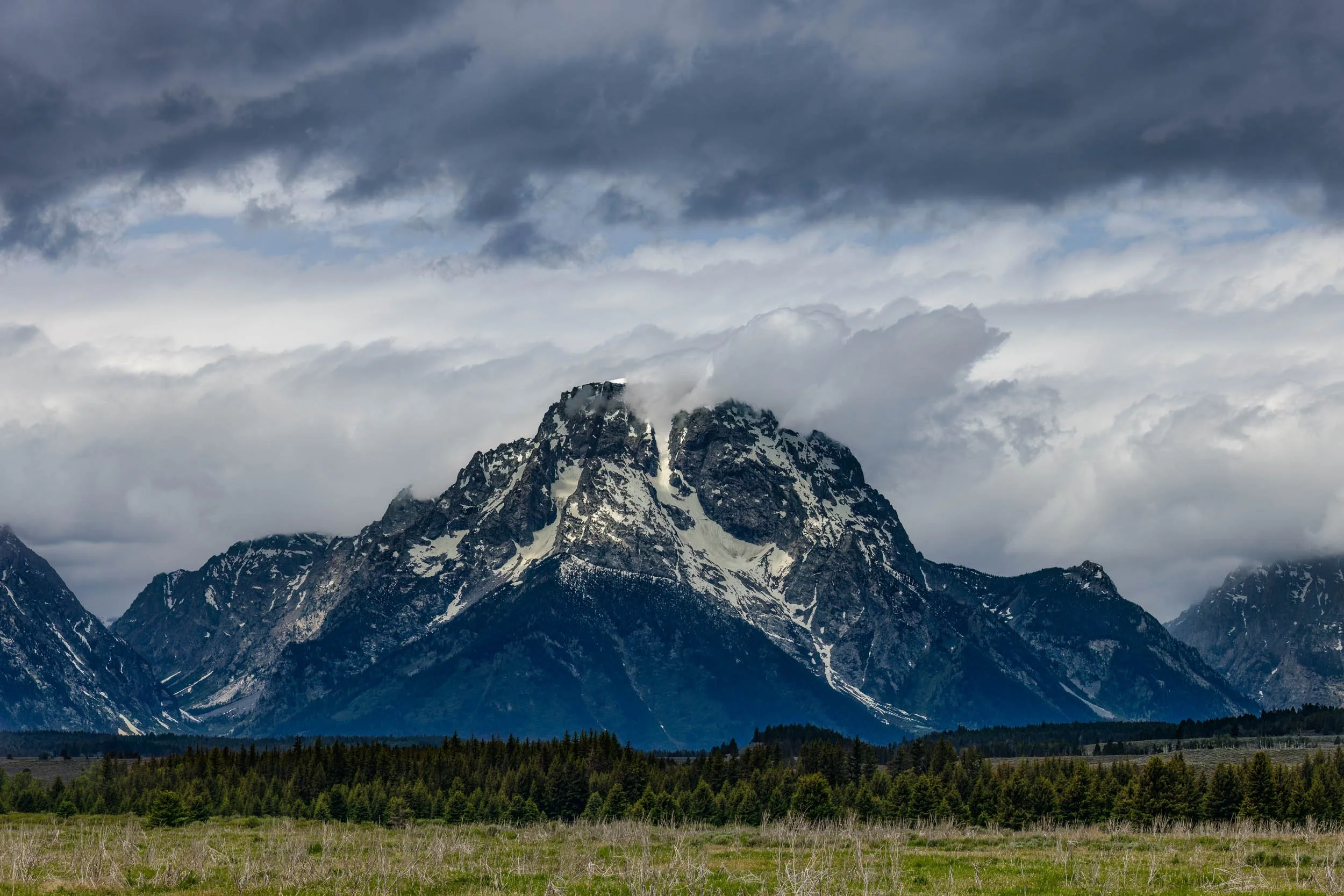  Moran Gloom 
While waiting for a tentative herd of elk to cross an open meadow, a crowd of photographers quickly gathered along the roadside. Amidst the distraction of the crowd, I looked up and noticed how beautifully the stormy clouds were moving 