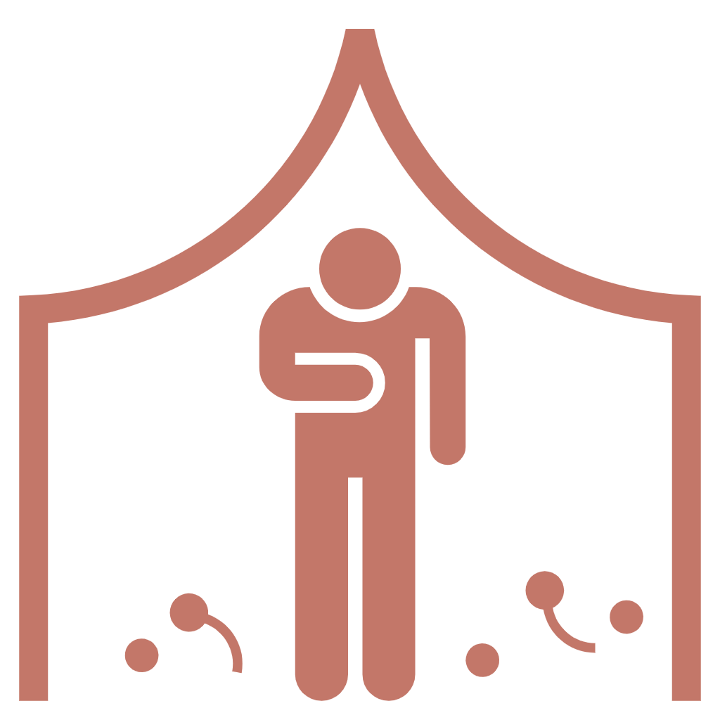 A person standing inside a shower or shower tent, with droplets of water on the floor.