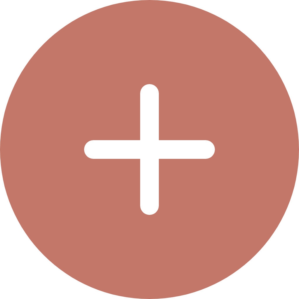 Close-up of a round, pinkish-brown object with a black plus symbol in the center.