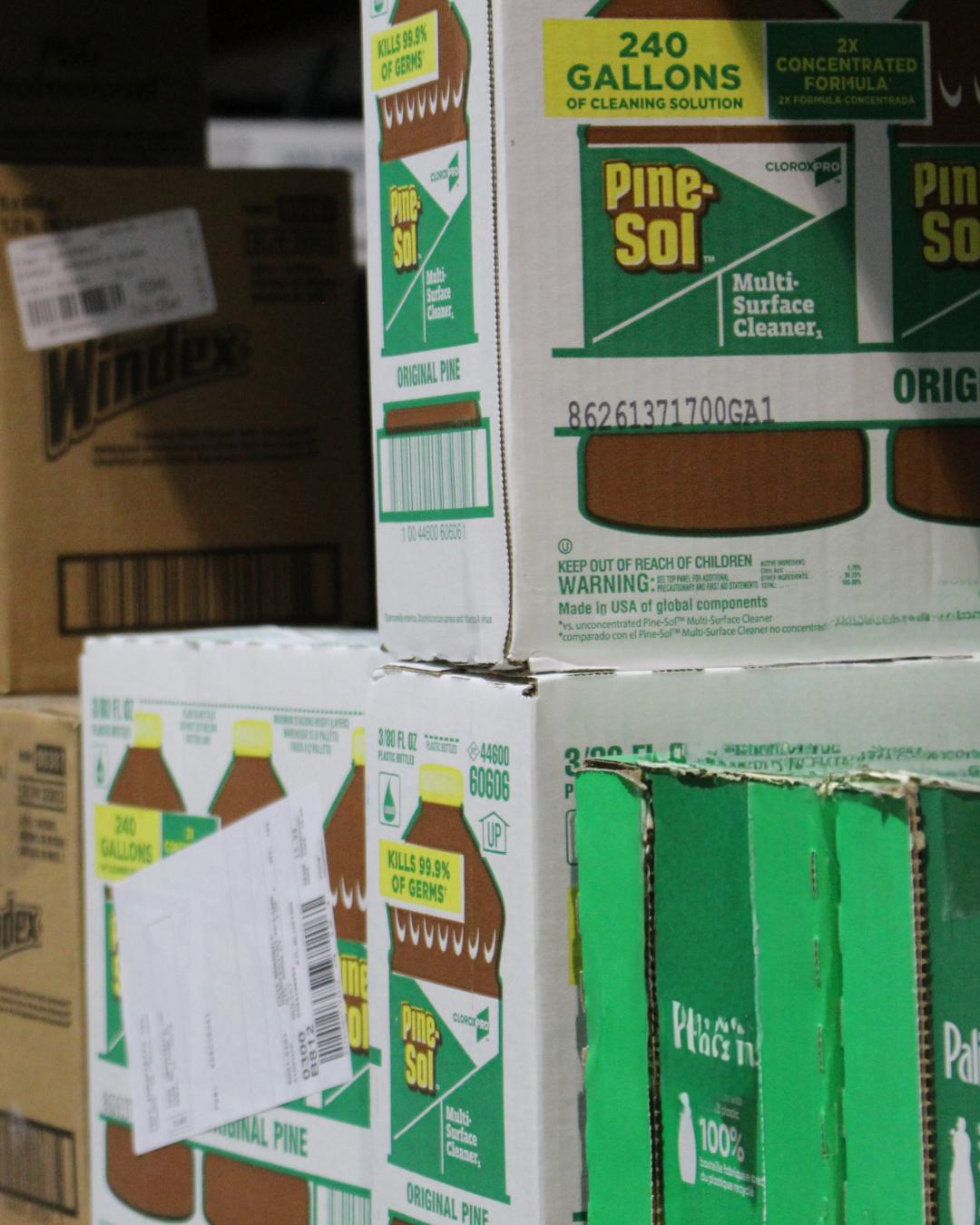 Boxes of Pine-Sol multi-surface cleaner with green and white packaging, featuring a brown and yellow bottle graphic, forest green and yellow text, and a label indicating 240 gallons of cleaning solution and 99.9% germ-killing effectiveness.