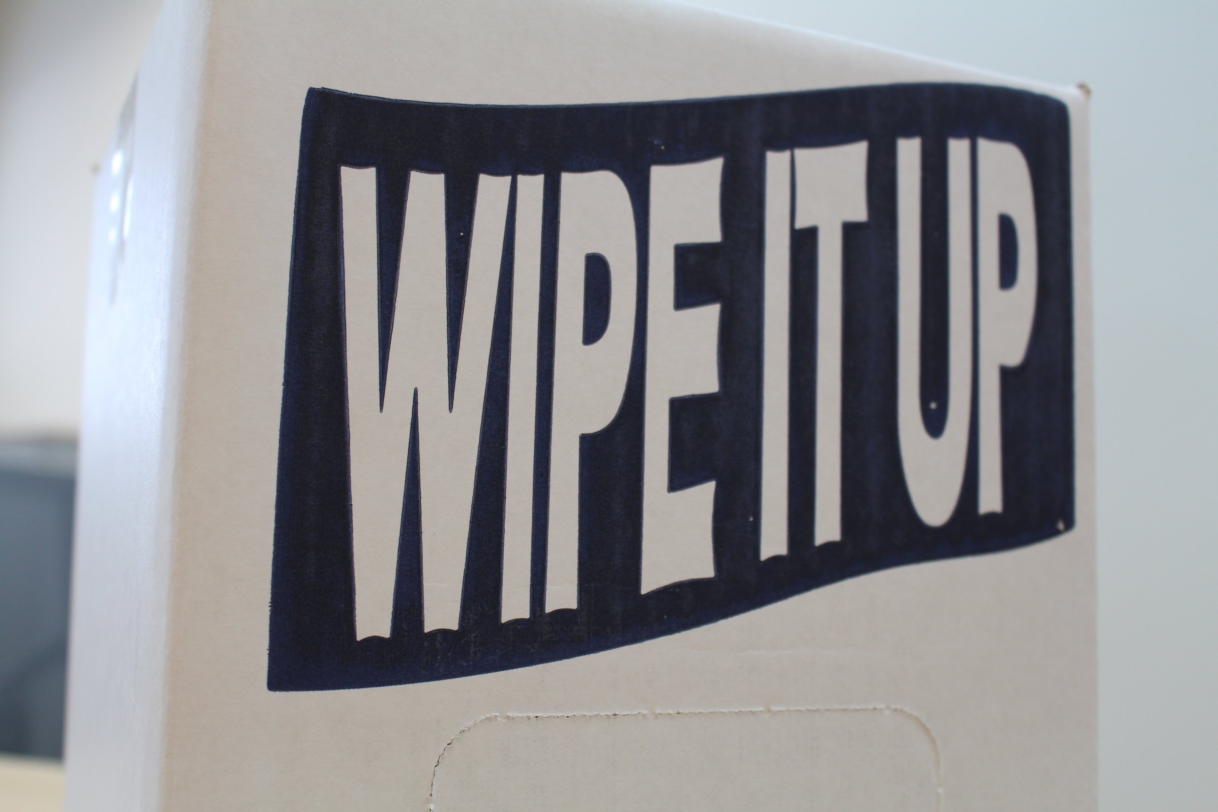 Close-up of a black sticker with white text that reads "YOUR EYES" on a white surface.