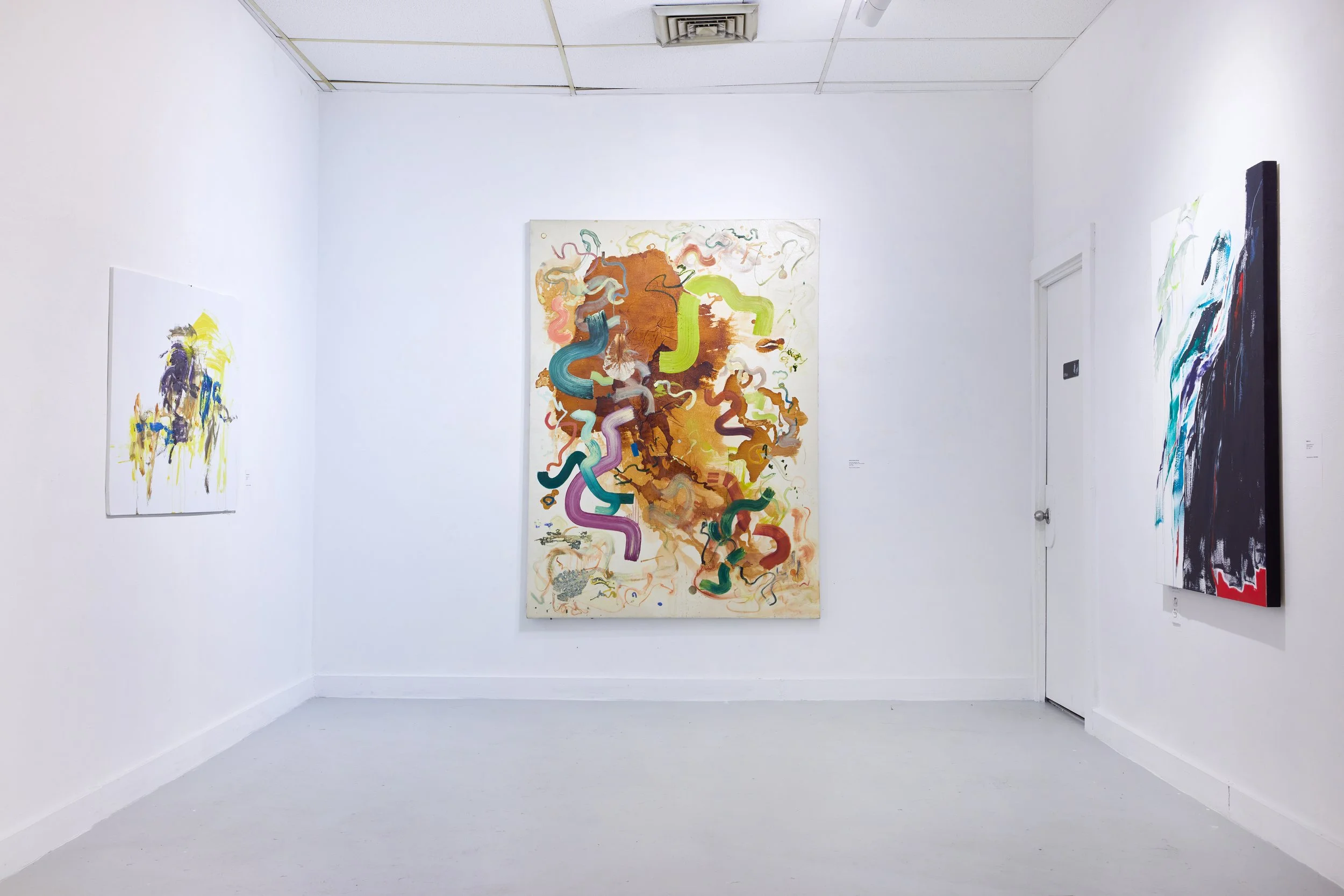 Art gallery with three abstract paintings on white walls and a white floor.