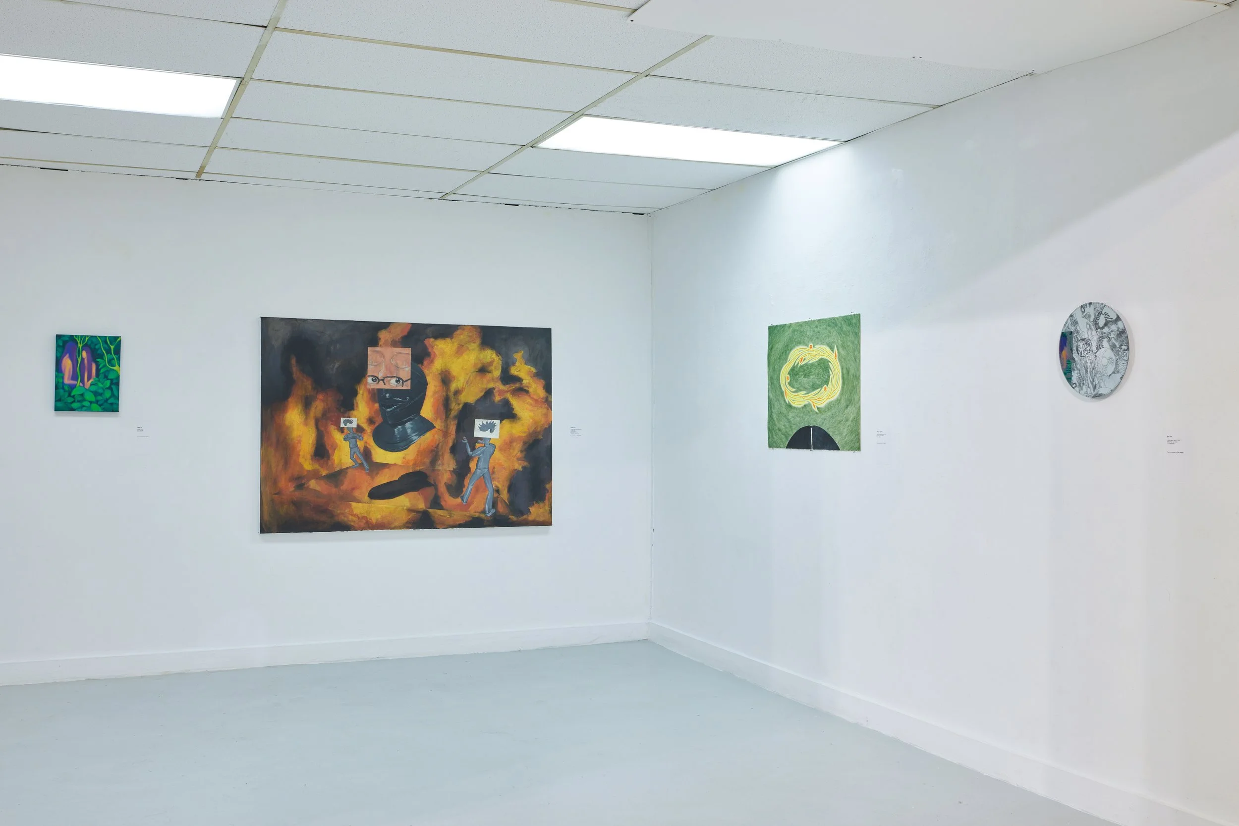 Art gallery with white walls, featuring several colorful paintings. The gallery has a simple design with fluorescent lighting on the ceiling.