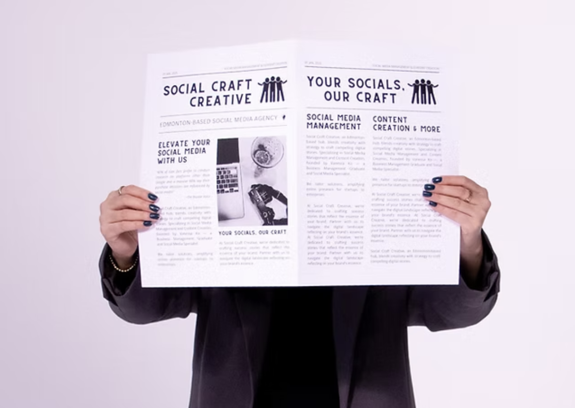Person holding a printed brochure about social media management and content creation.