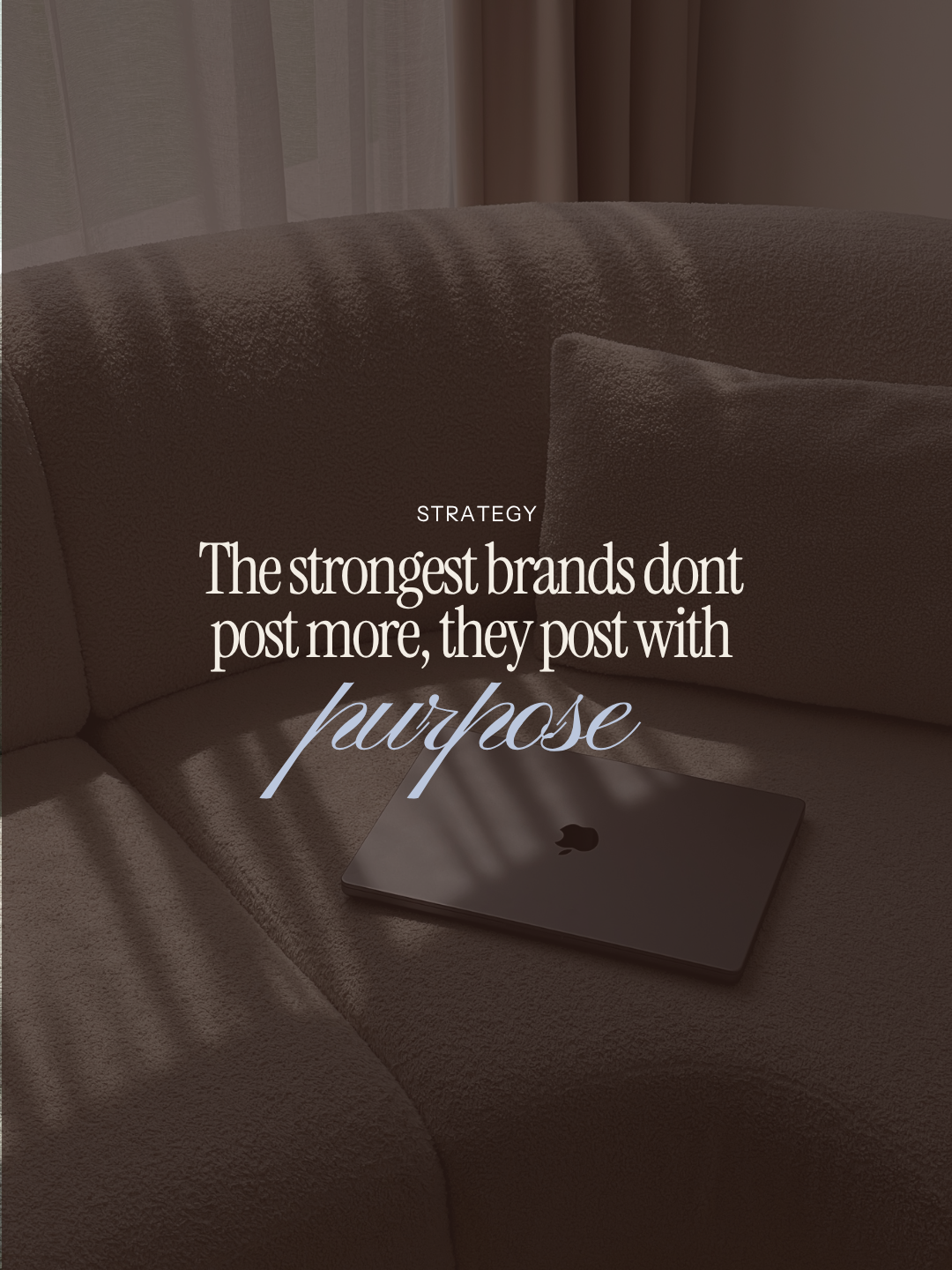 A closed MacBook on a beige sofa with a quote overlayed that reads, "The strongest brands don't post more, they post with purpose."