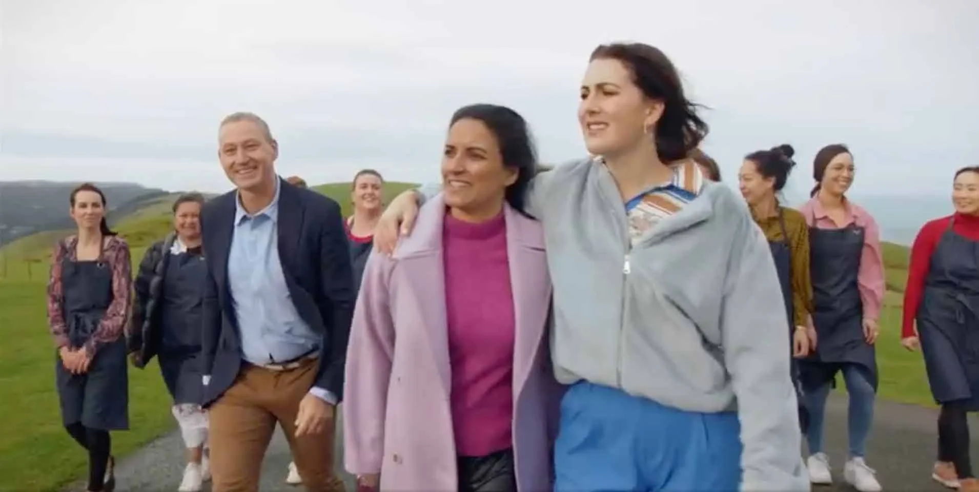 Diverse group of people walking together on a coastal countryside path