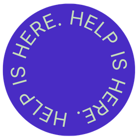 Purple circular sign with white text that says 'HELP IS HERE. HELP IS HERE. HELP IS HERE.'