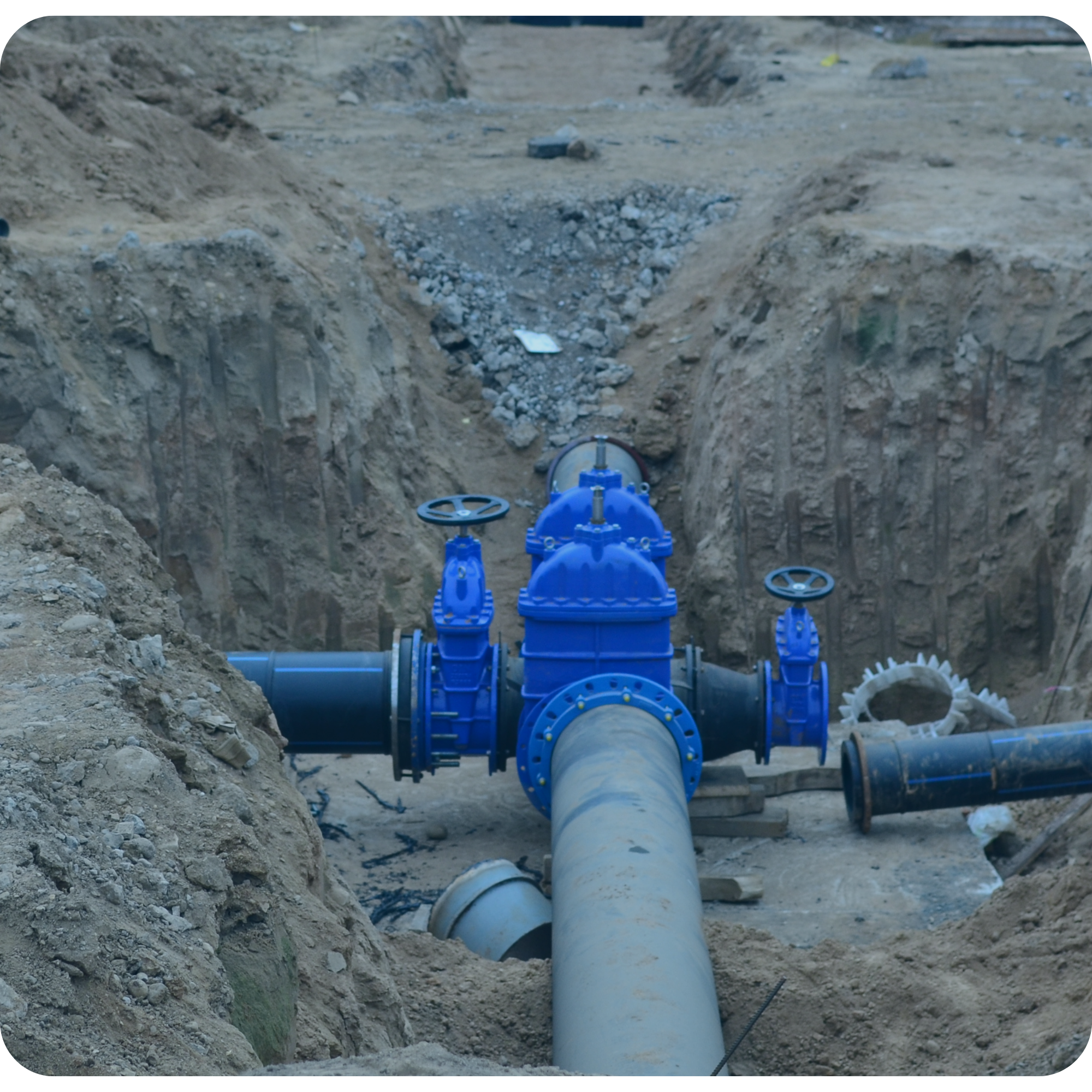 Underground trench excavation featuring blue gate valves and heavy pipework for a $370K council water main upgrade in Blenheim, managed by My EstiMate.