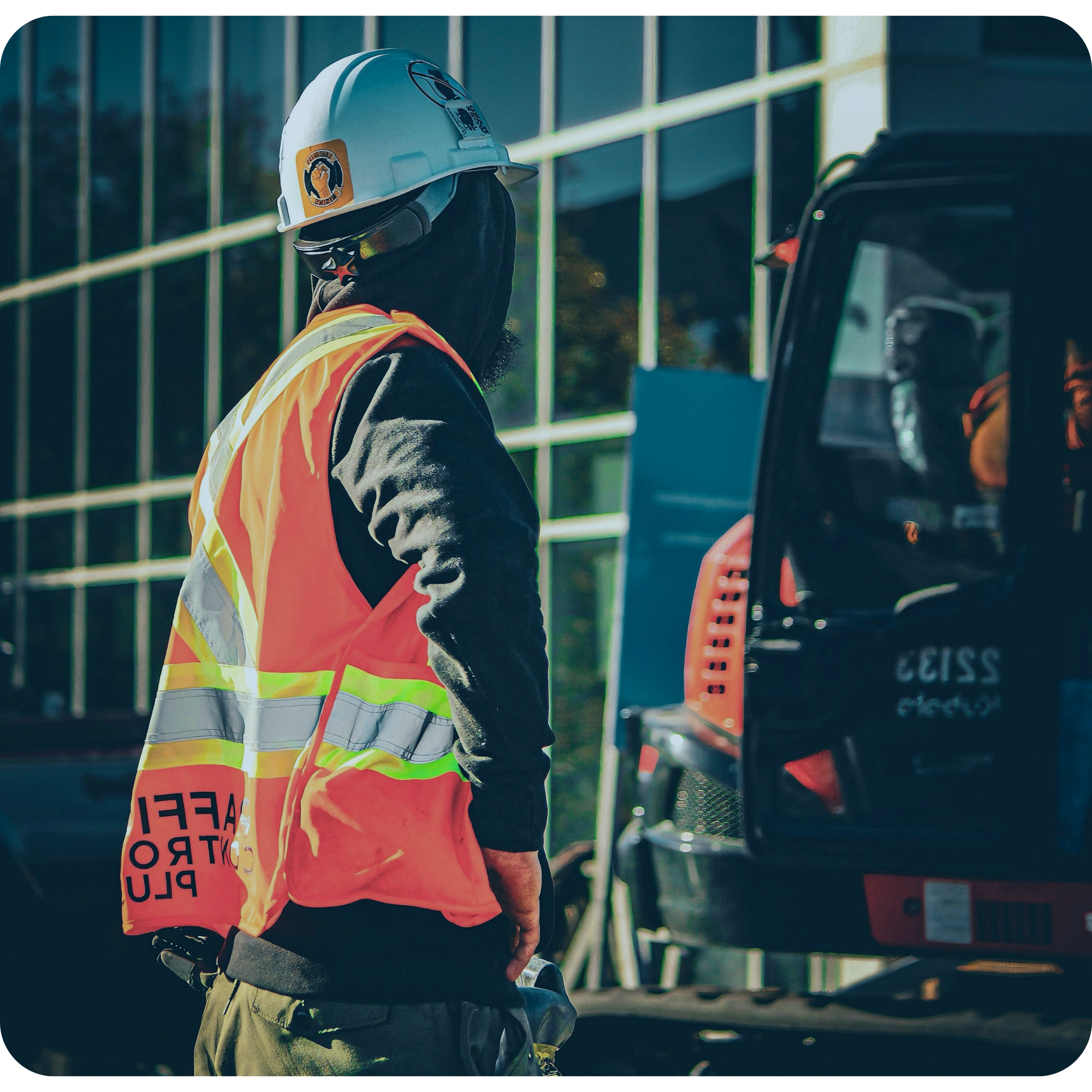 Civil construction worker in high-vis gear alongside an excavator on a commercial site managed with My EstiMate tender takeoff services.