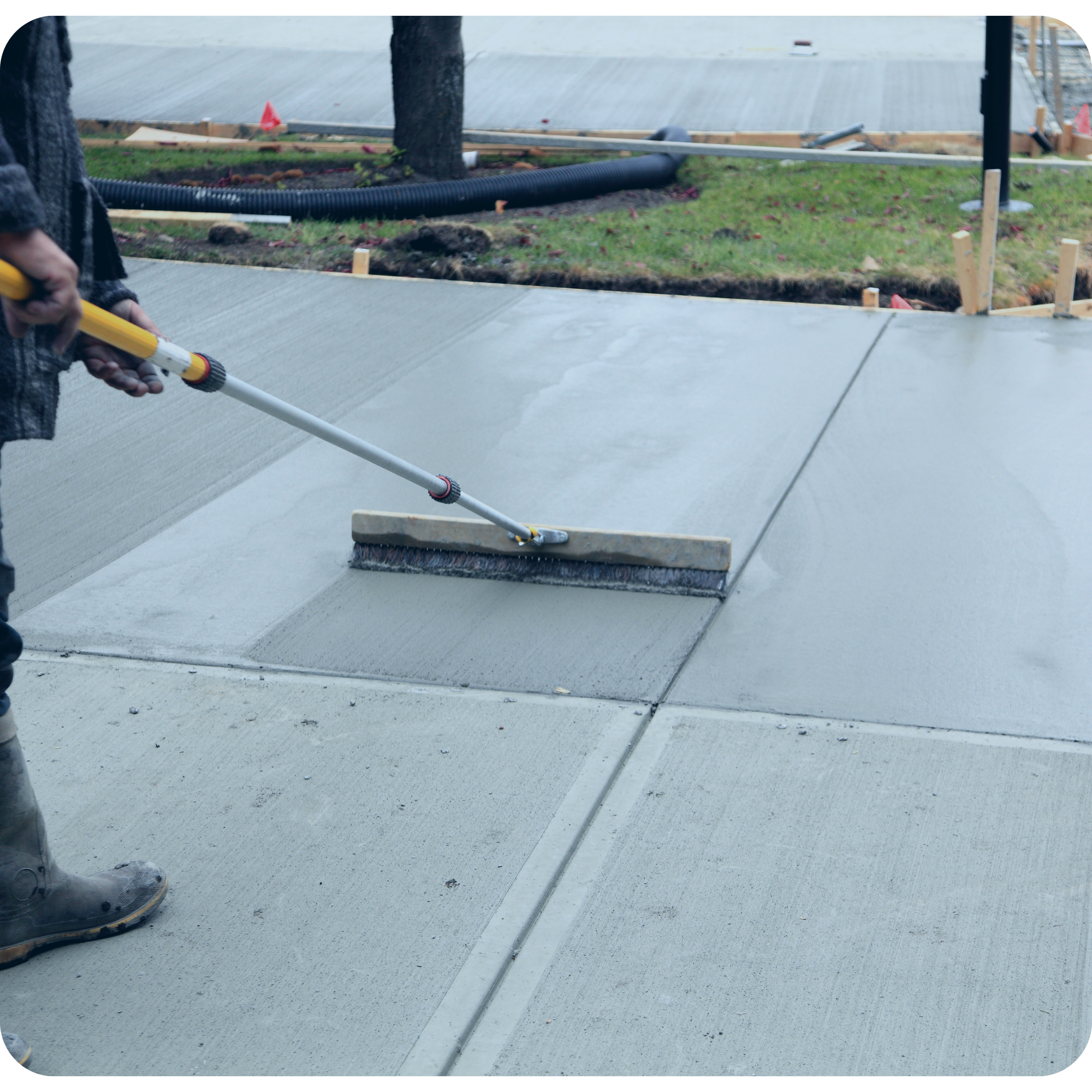 Broomed concrete surface finishing and drainage prep for an $8K right-of-way driveway replacement project in Blenheim, managed with My EstiMate procurement and tender pricing.
