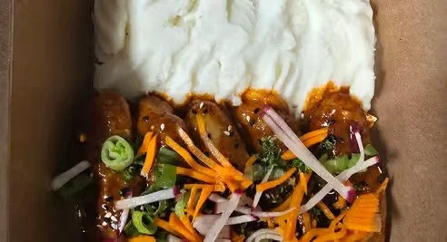 Tofu with mixed vegetables and sauce, served with white rice.