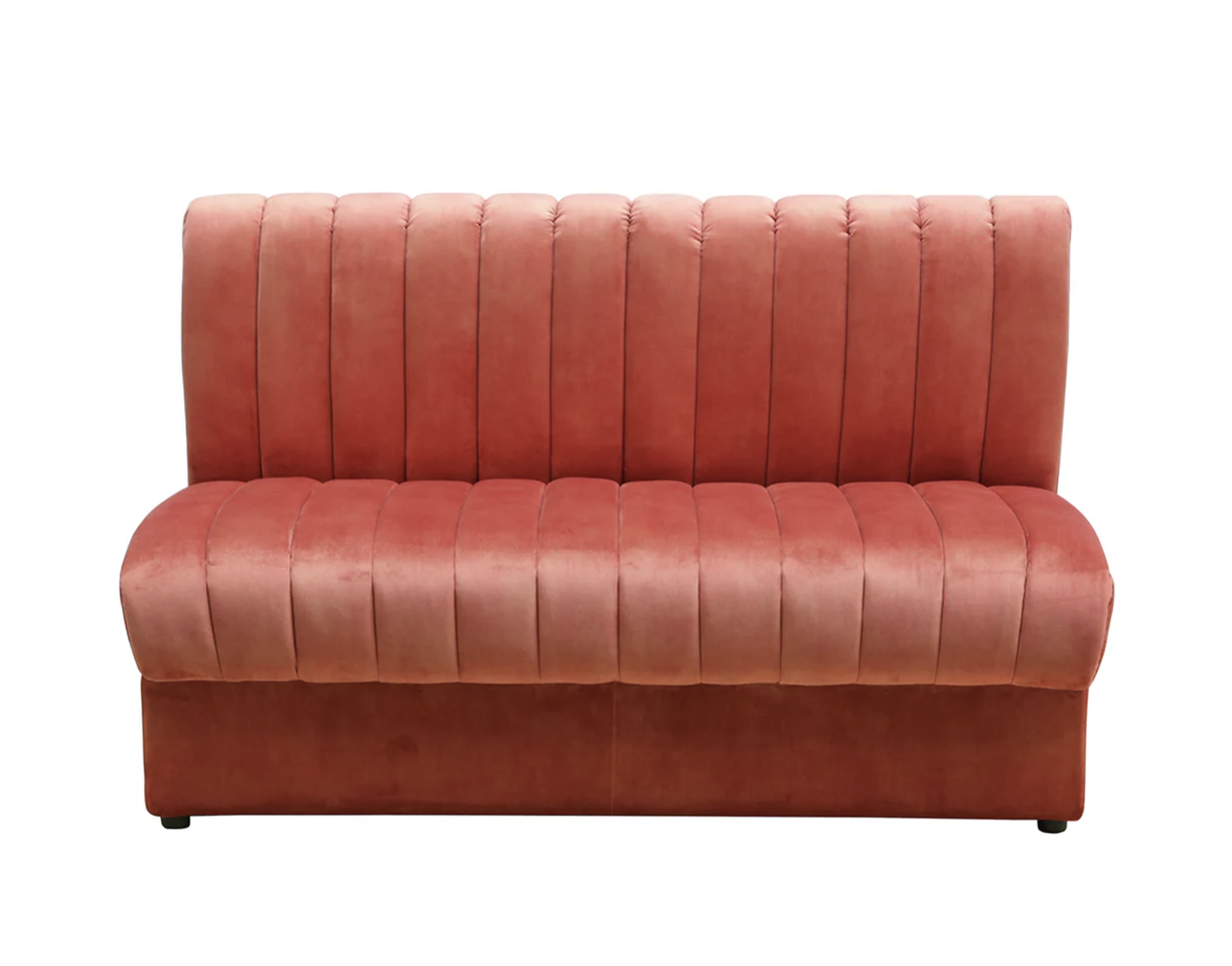 A pink upholstered bench with a tall backrest and vertical tufted design.