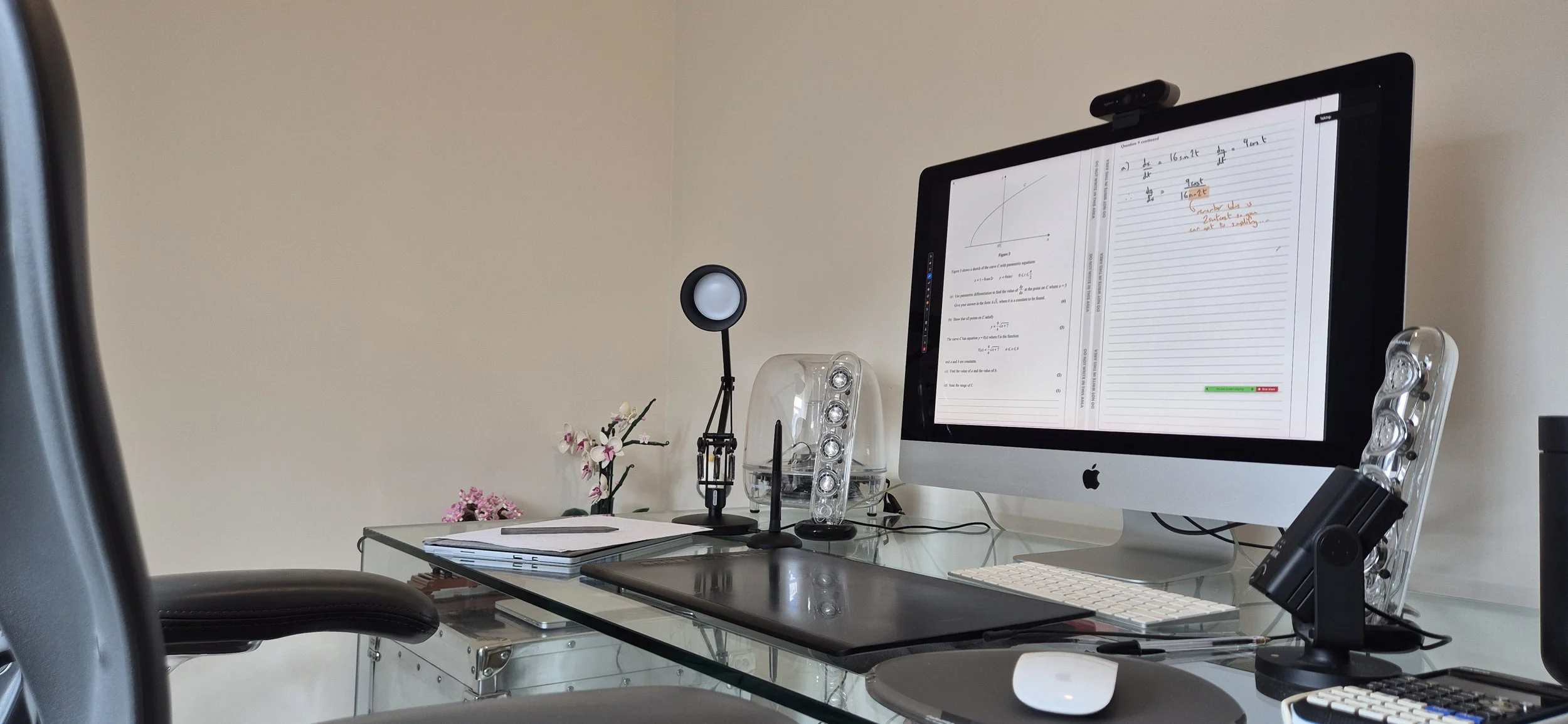 Dedicated online maths tuition workspace with a large monitor, webcam, microphone and graphics tablet.
