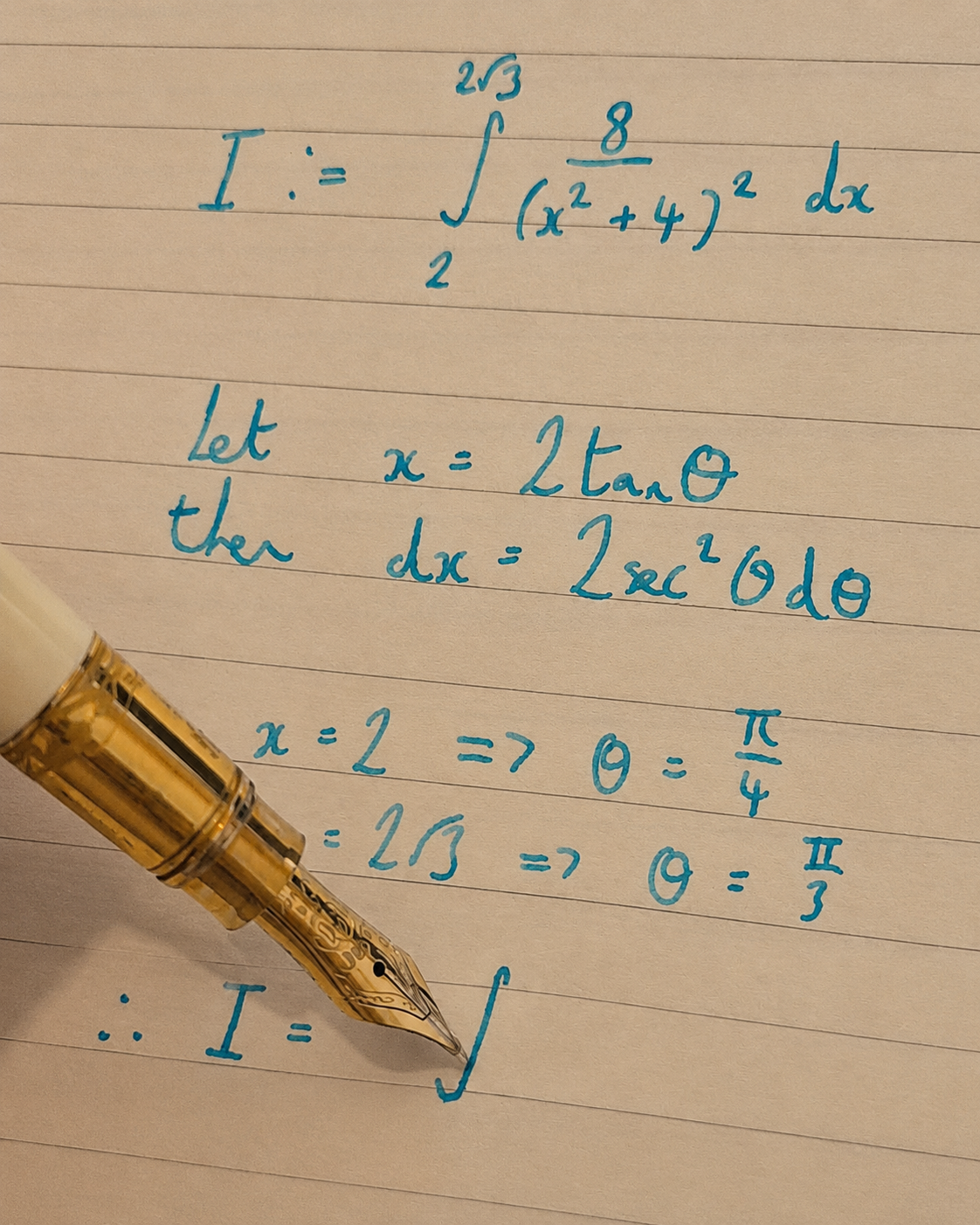 Handwritten integration problem worked using a trigonometric substitution, alongside a fountain pen.