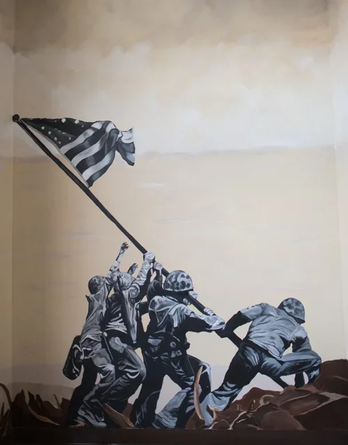 Murale of soldiers raising the American flag on a hill.
