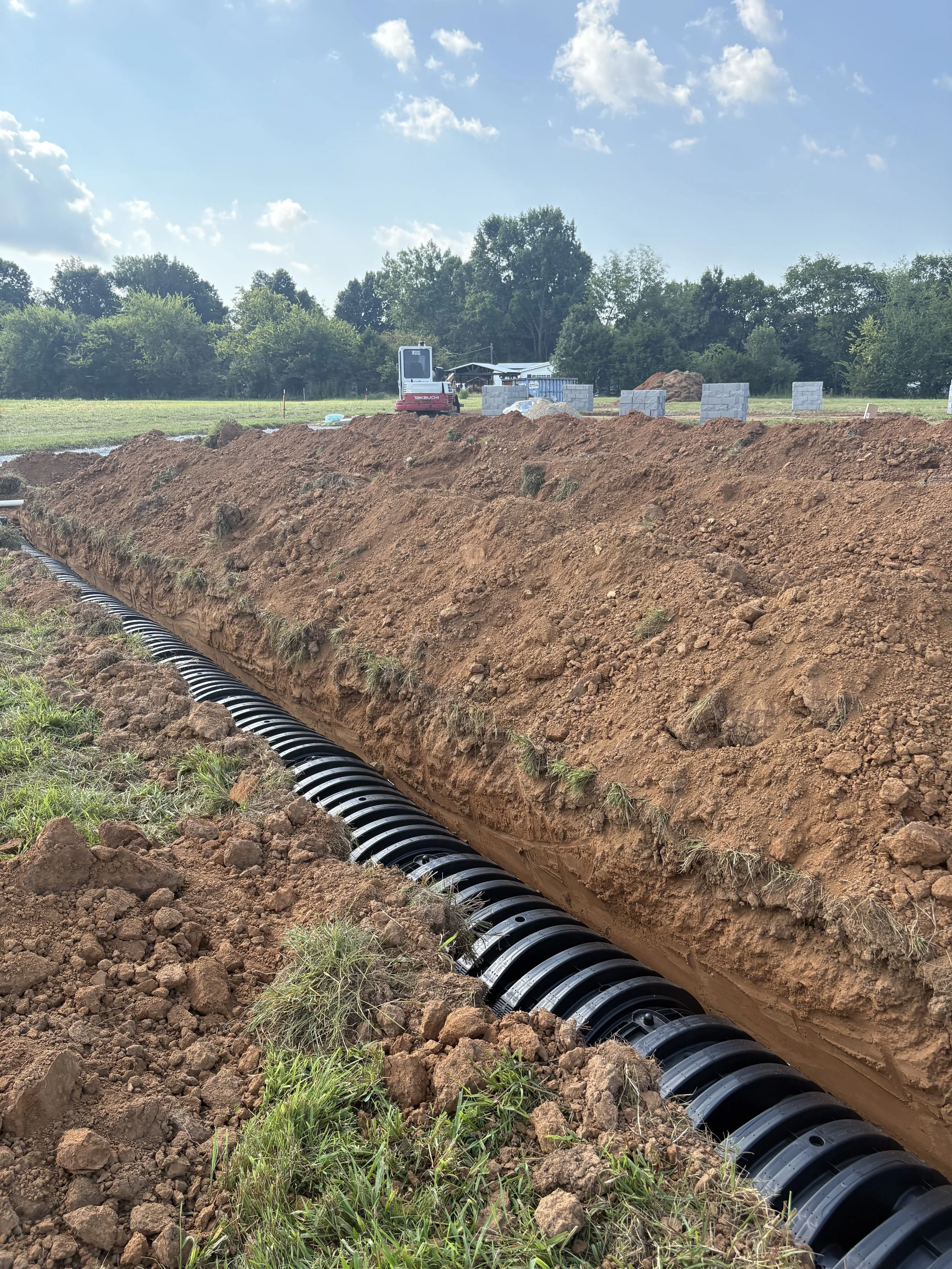 Trench and line dug to the precise depth using a laser to ensure correct fall. 
This system was installed in Chapel Hill, TN