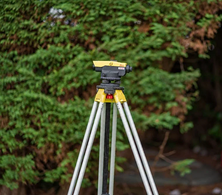 Surveying instrument on a tripod for measuring site levels.