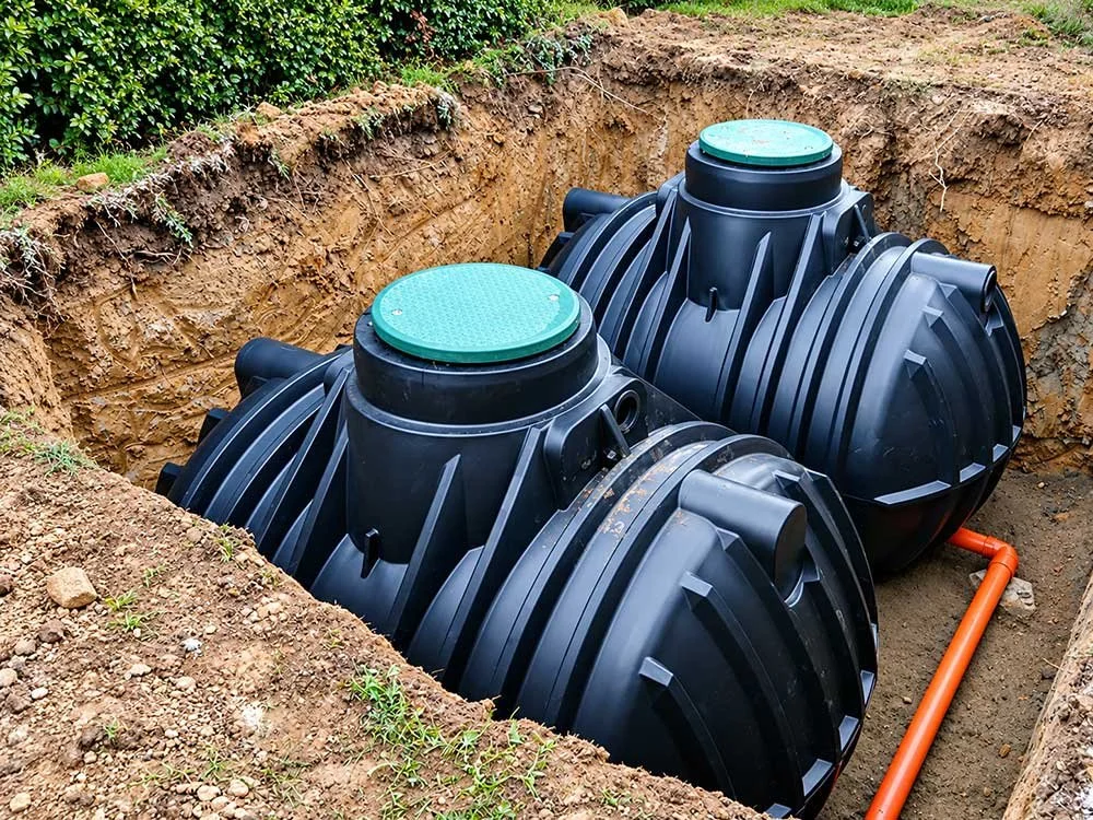 Two underground drainage tanks positioned in an excavation.