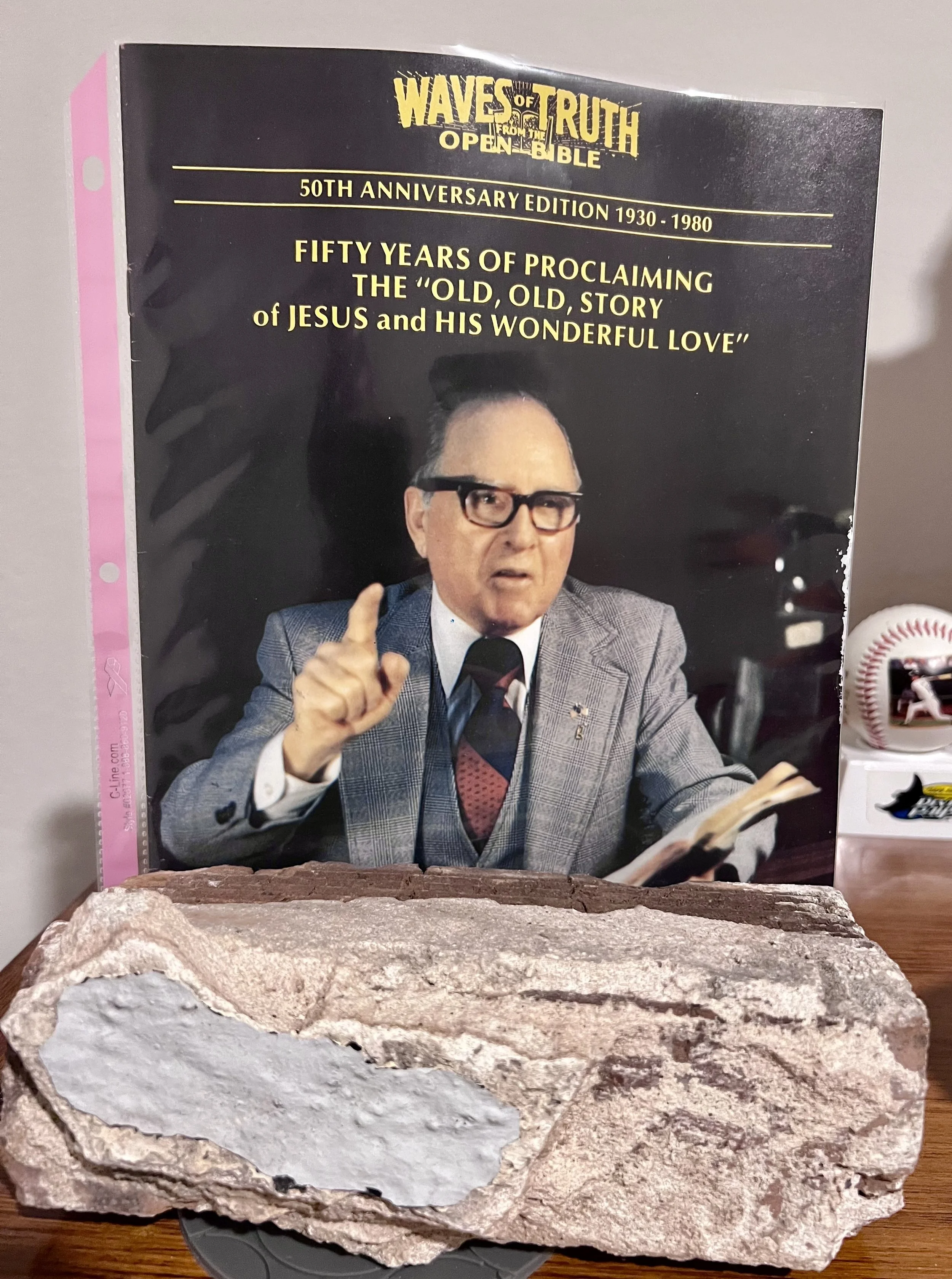 The Waves Of Truth Magazine and a brick from Faith Temple Church in the foreground.