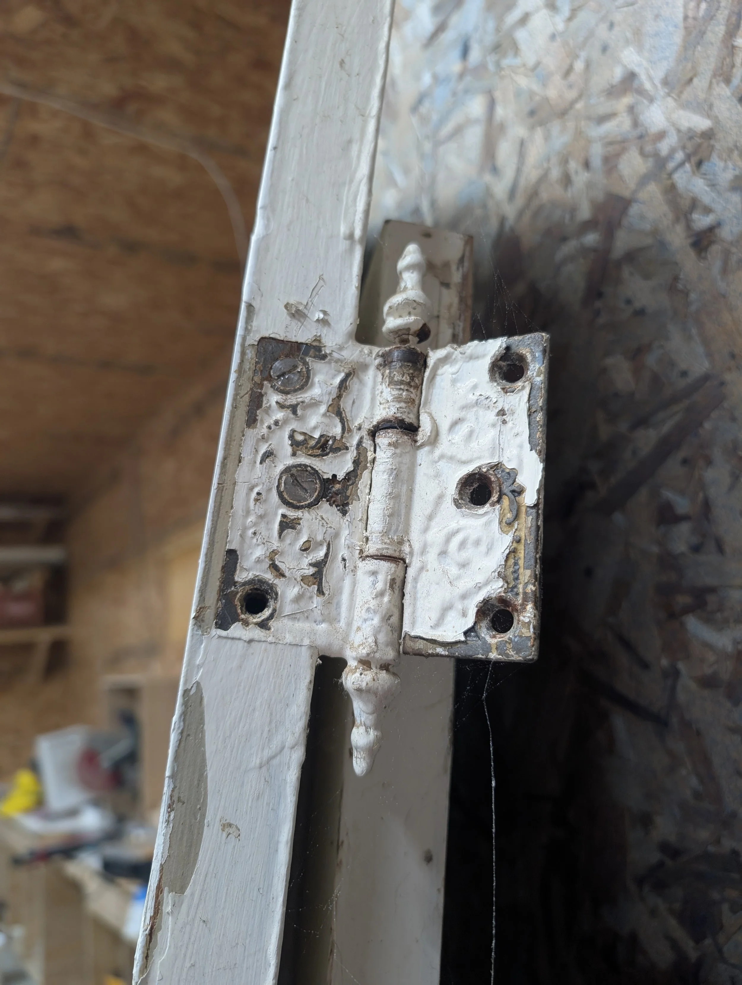 BEFORE: Original door hinges, painted over multiple times and rusted