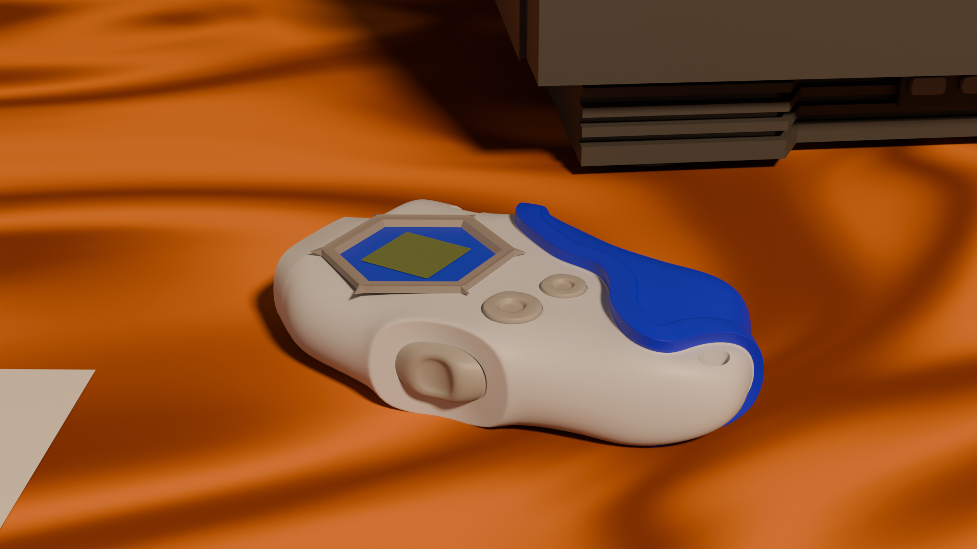 A white video game controller with blue accents lying on an orange fabric surface beneath a dark brown piece of furniture.