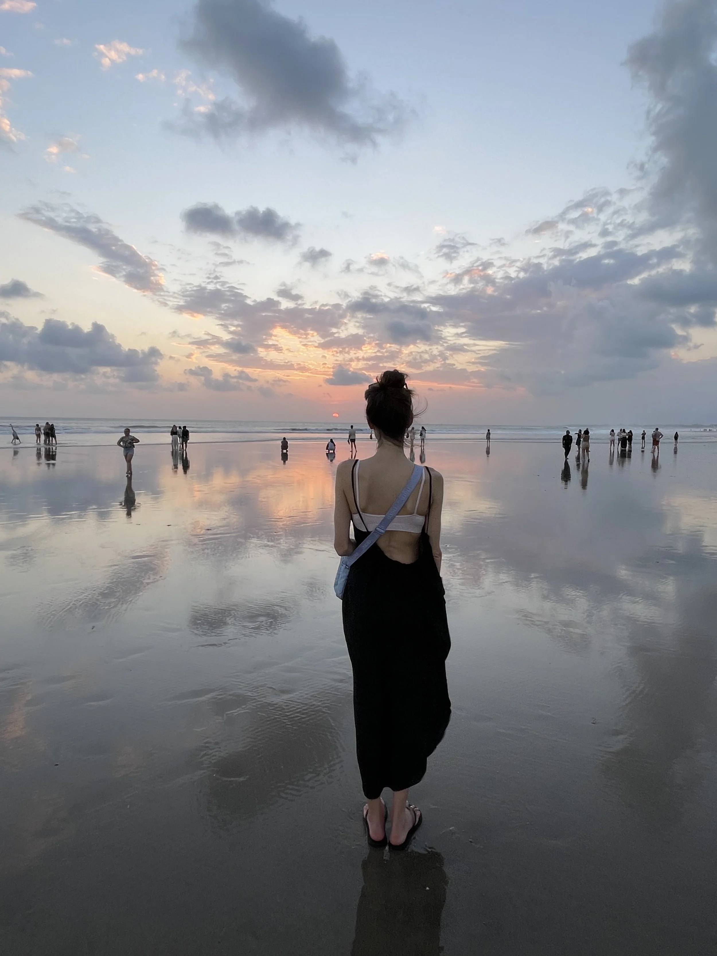Charlette Bree watching a sunset on Seminyak Beach in Bali.